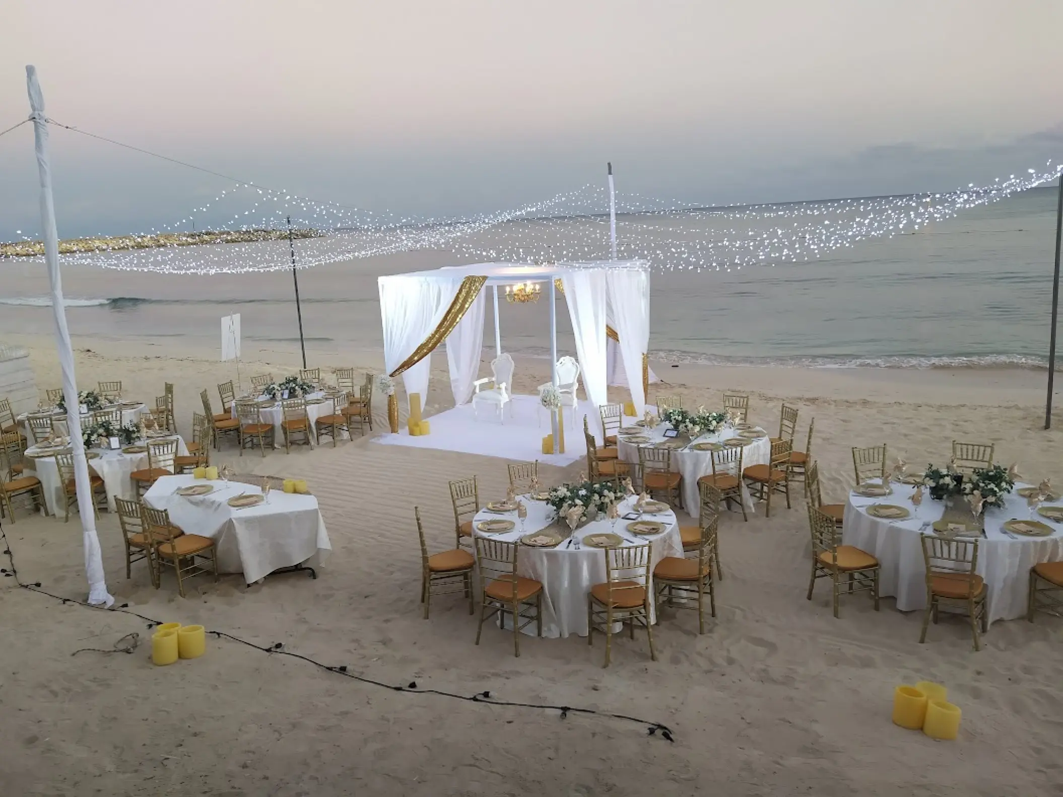 Beachfront wedding reception under string lights at Dreams Jade, Riviera Maya