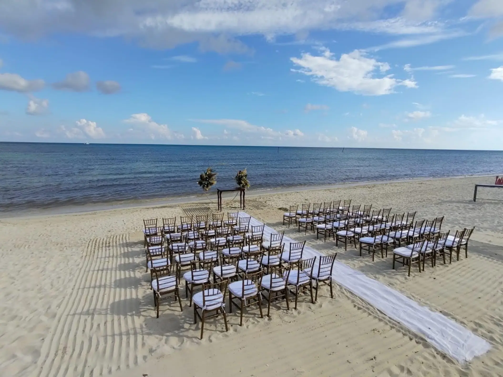 Beachfront wedding ceremony setup at Dreams Jade, Riviera Maya