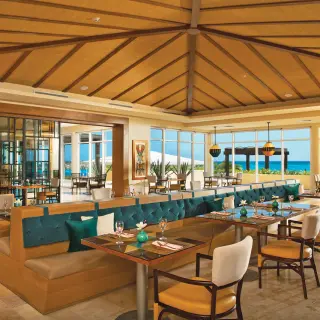 Indoor restaurant dining area with ocean views at Dreams Jade, Riviera Maya