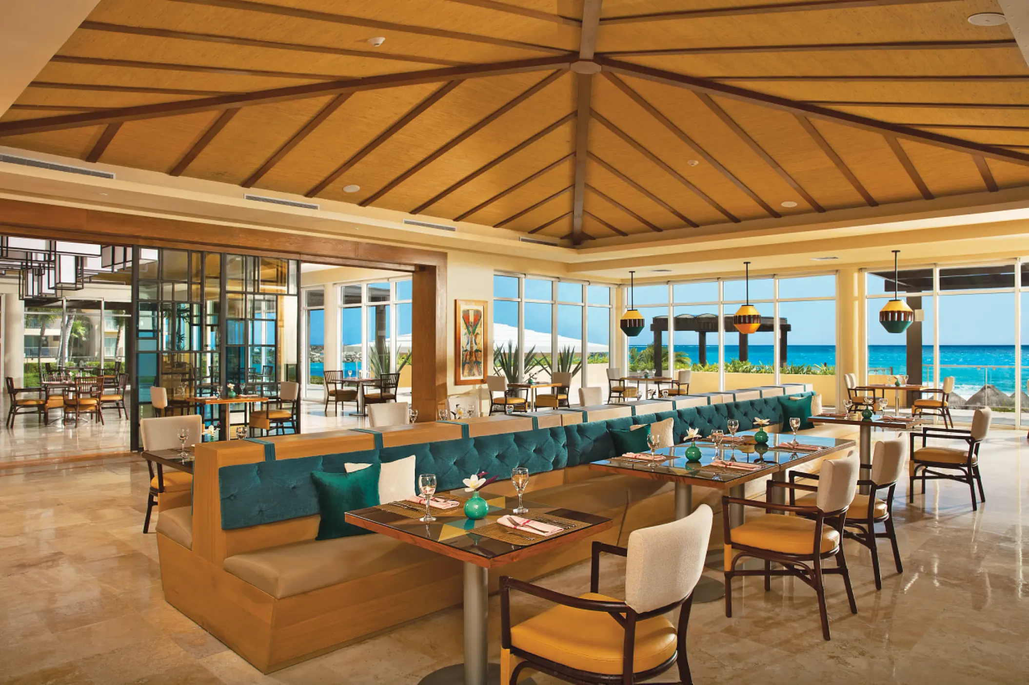 Indoor restaurant dining area with ocean views at Dreams Jade, Riviera Maya