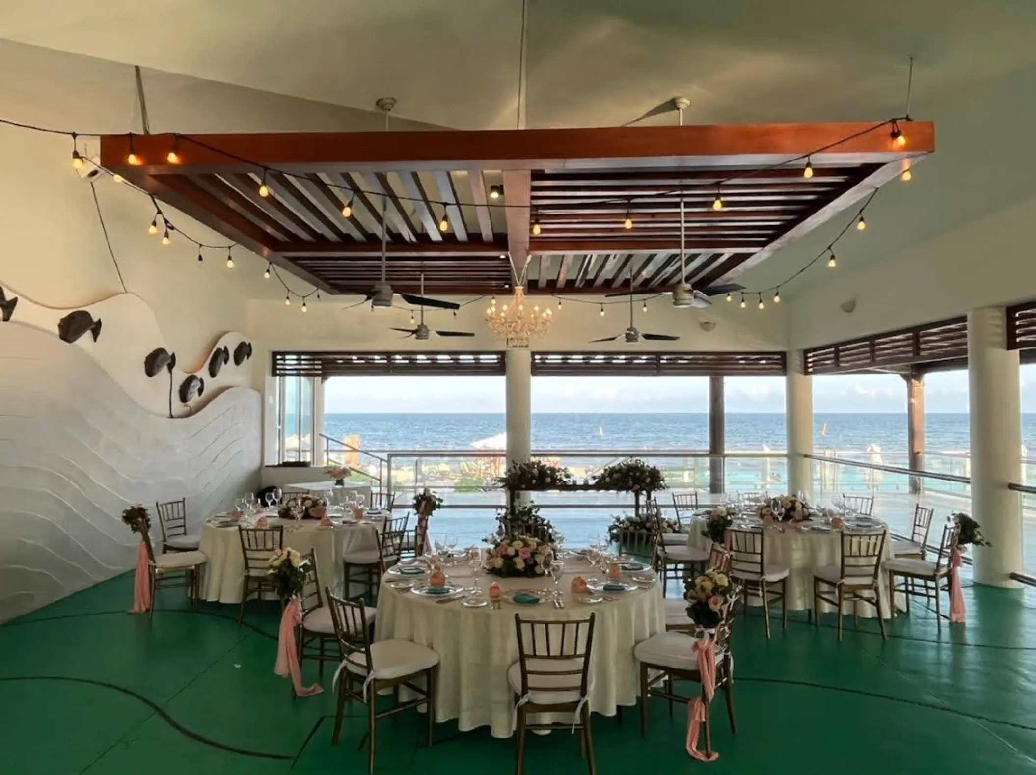 Wedding reception with round tables and bistro lighting at Dreams Jade, Riviera Maya