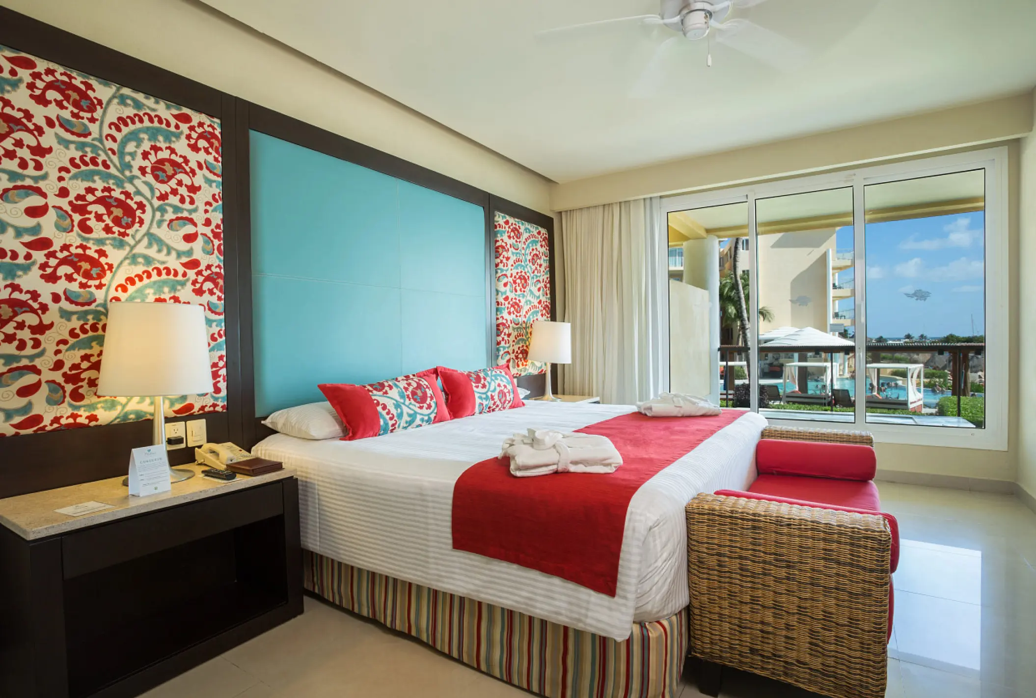 King suite with red accents and ocean view terrace at Dreams Jade, Riviera Maya