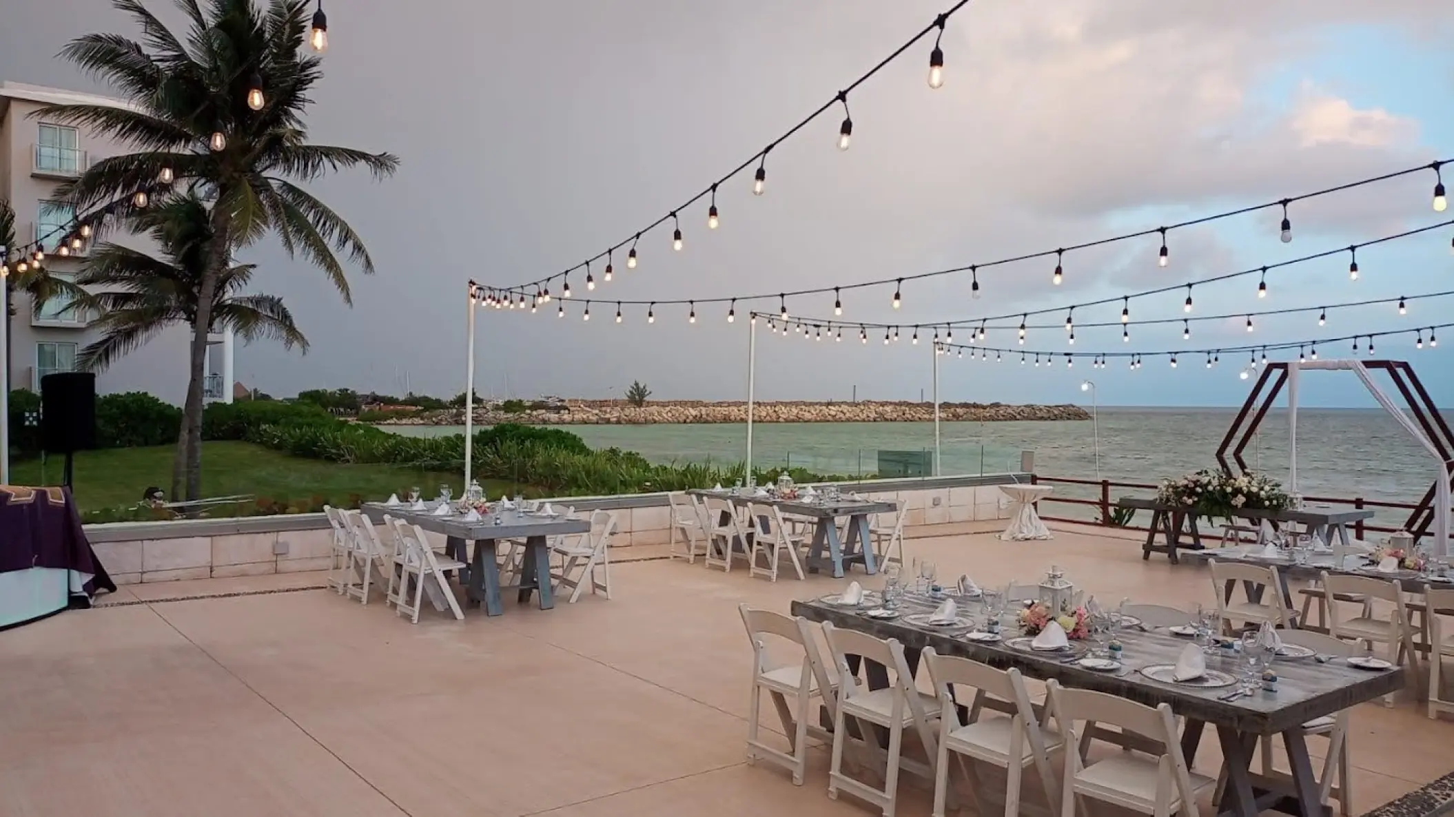 Outdoor terrace wedding reception with string lights at Dreams Jade, Riviera Maya