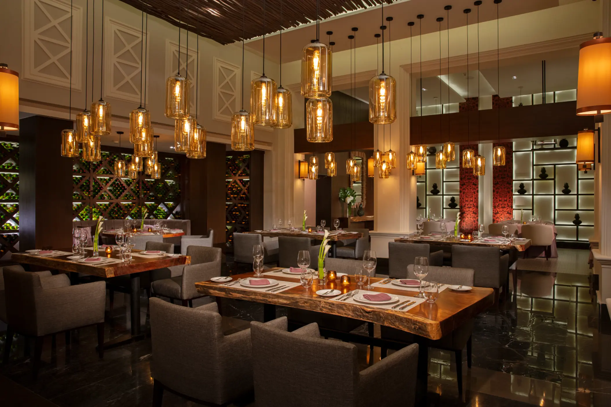 Mexican restaurant with amber lantern lighting and wood tables at Dreams Jade, Riviera Maya