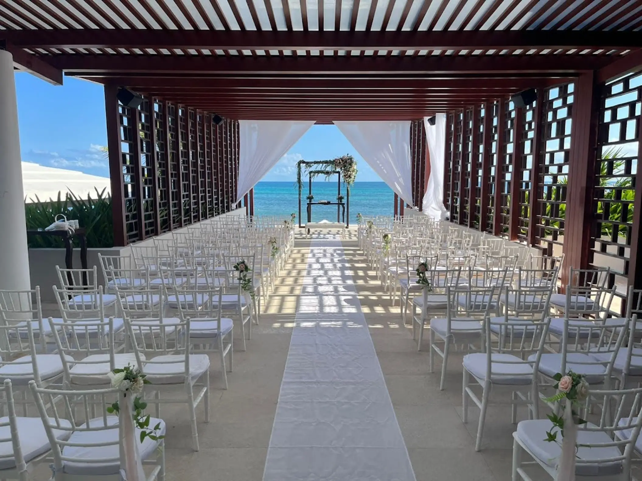 Oceanfront wedding ceremony at the pergola deck of Dreams Jade, Riviera Maya