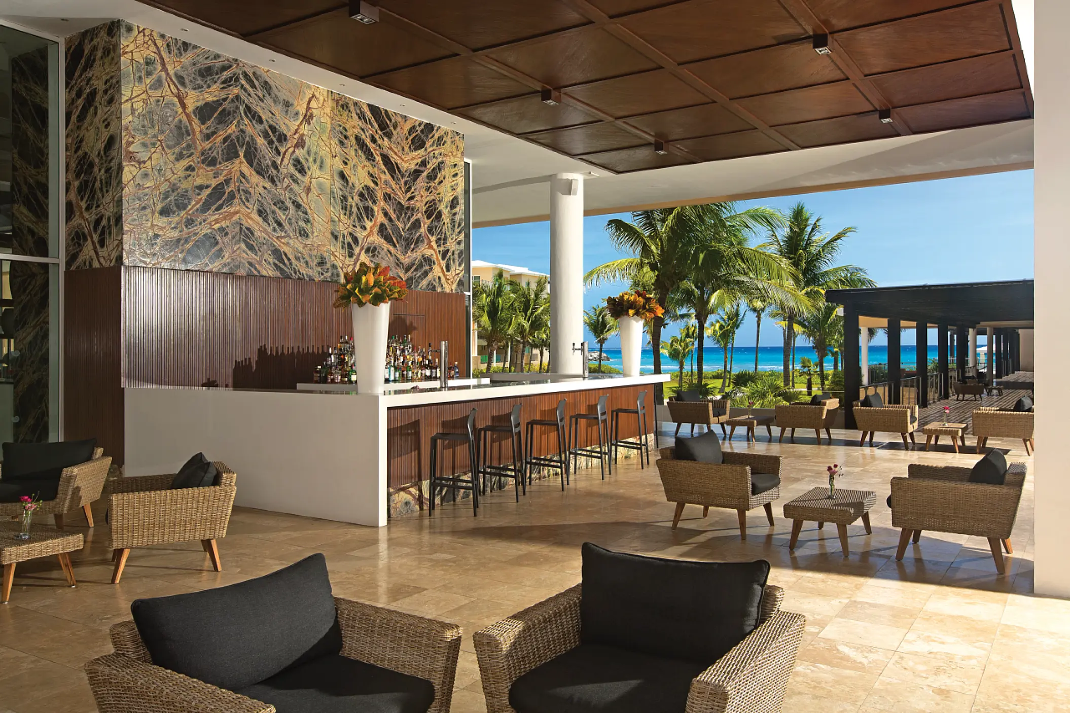 Time Out Bar lounge with wicker seating and ocean views at Dreams Jade, Riviera Maya