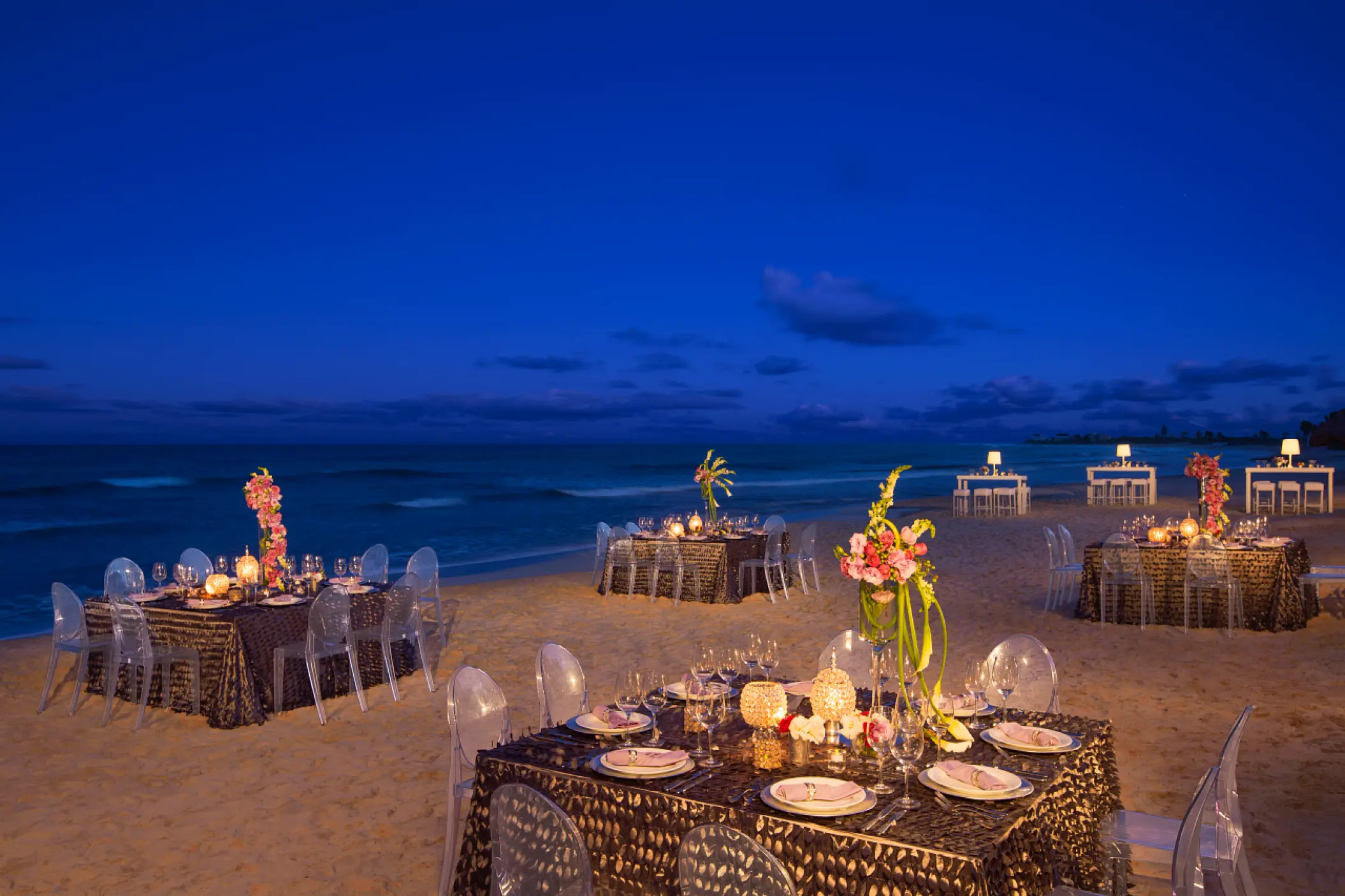 Beach wedding reception with candlelit tables at Dreams Jade, Riviera Maya