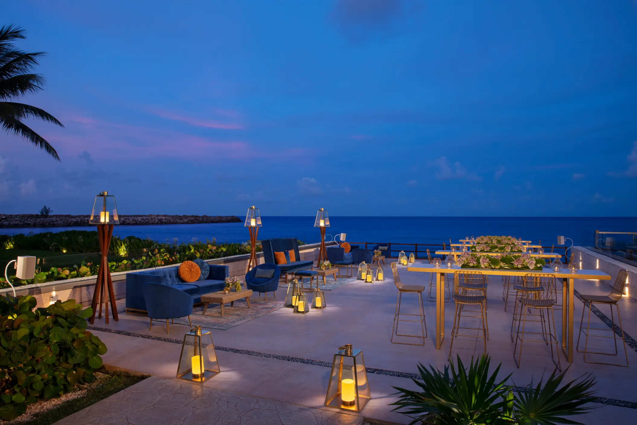 Oceanfront wedding reception terrace with lanterns at Dreams Jade, Riviera Maya
