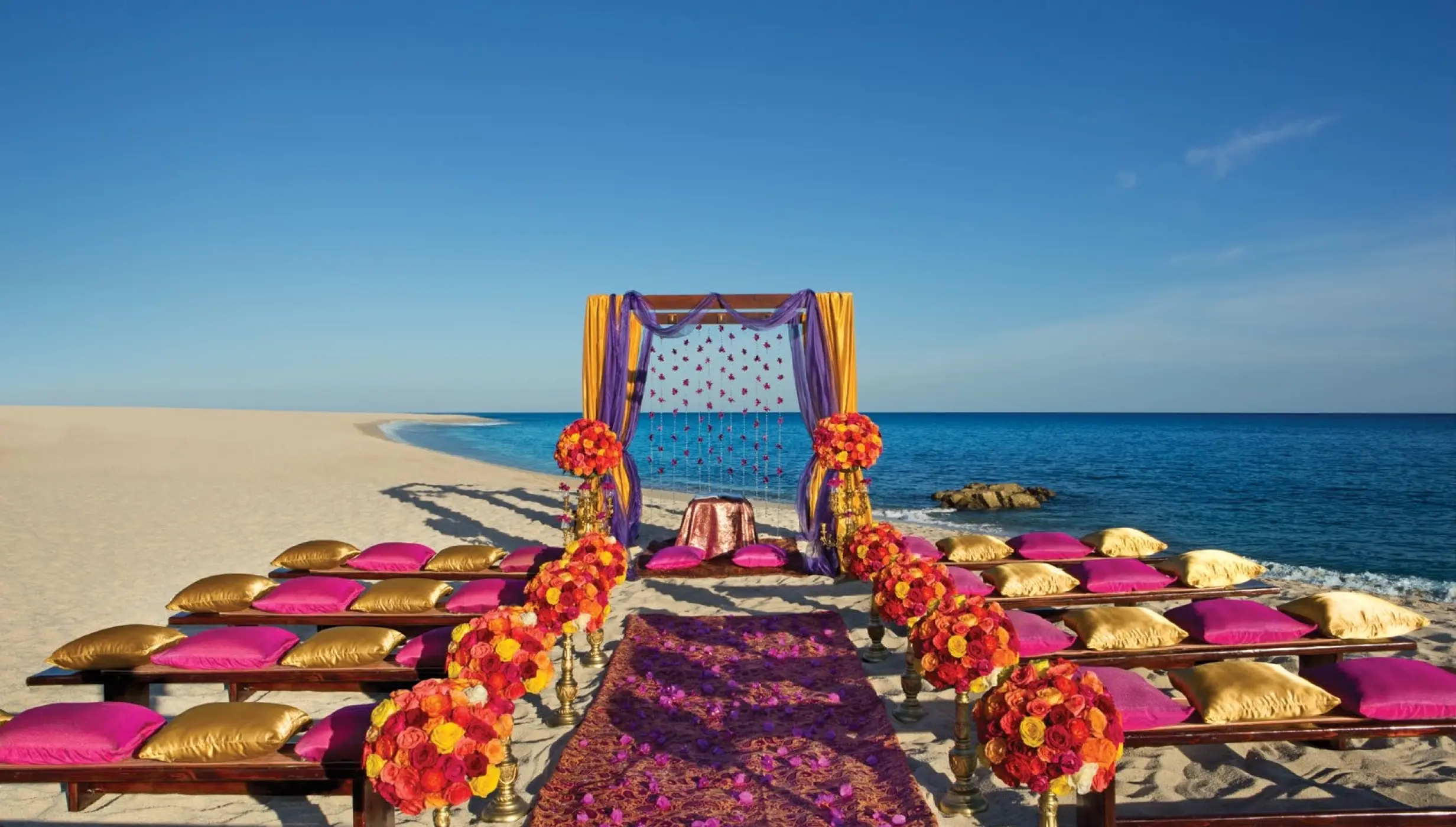 Ceremony decor on the beach at Dreams Los Cabos Suites Golf Resort & Spa