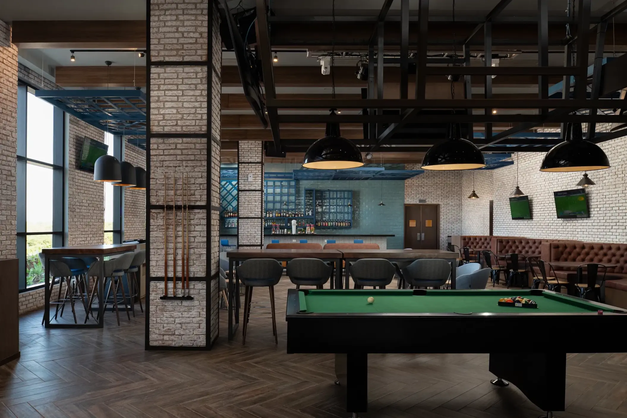 Sports bar with pool table and brick accents at Dreams Macao Beach, Punta Cana