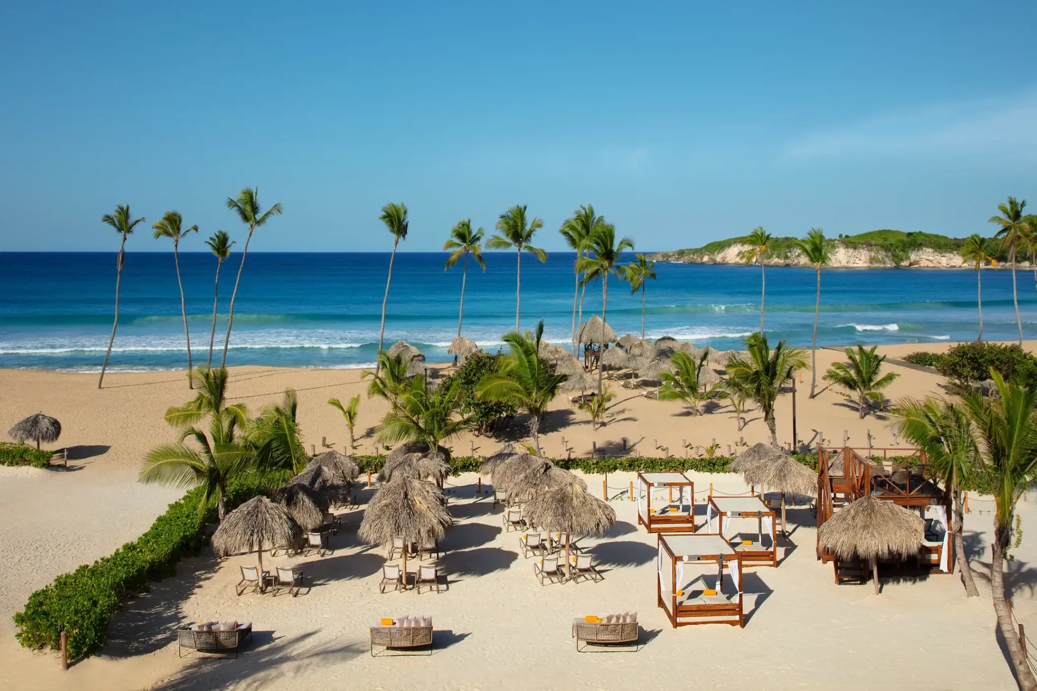 Beachfront area with palapas and cabanas at Dreams Macao Beach, Punta Cana