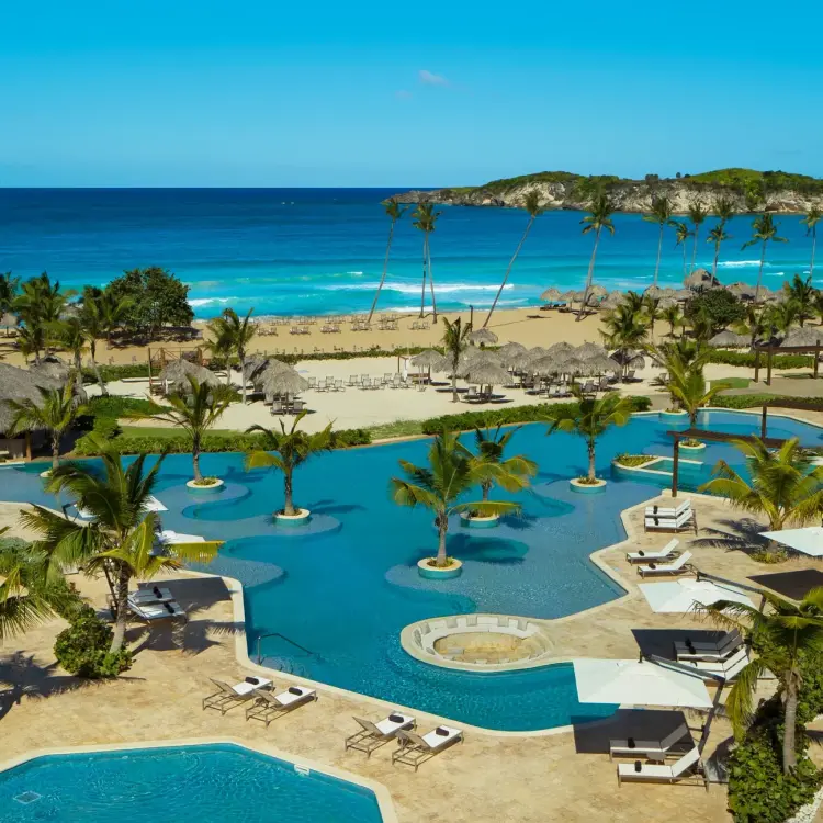 Dreams Macao Beach infinity pool and palm trees overlooking the ocean, Punta Cana