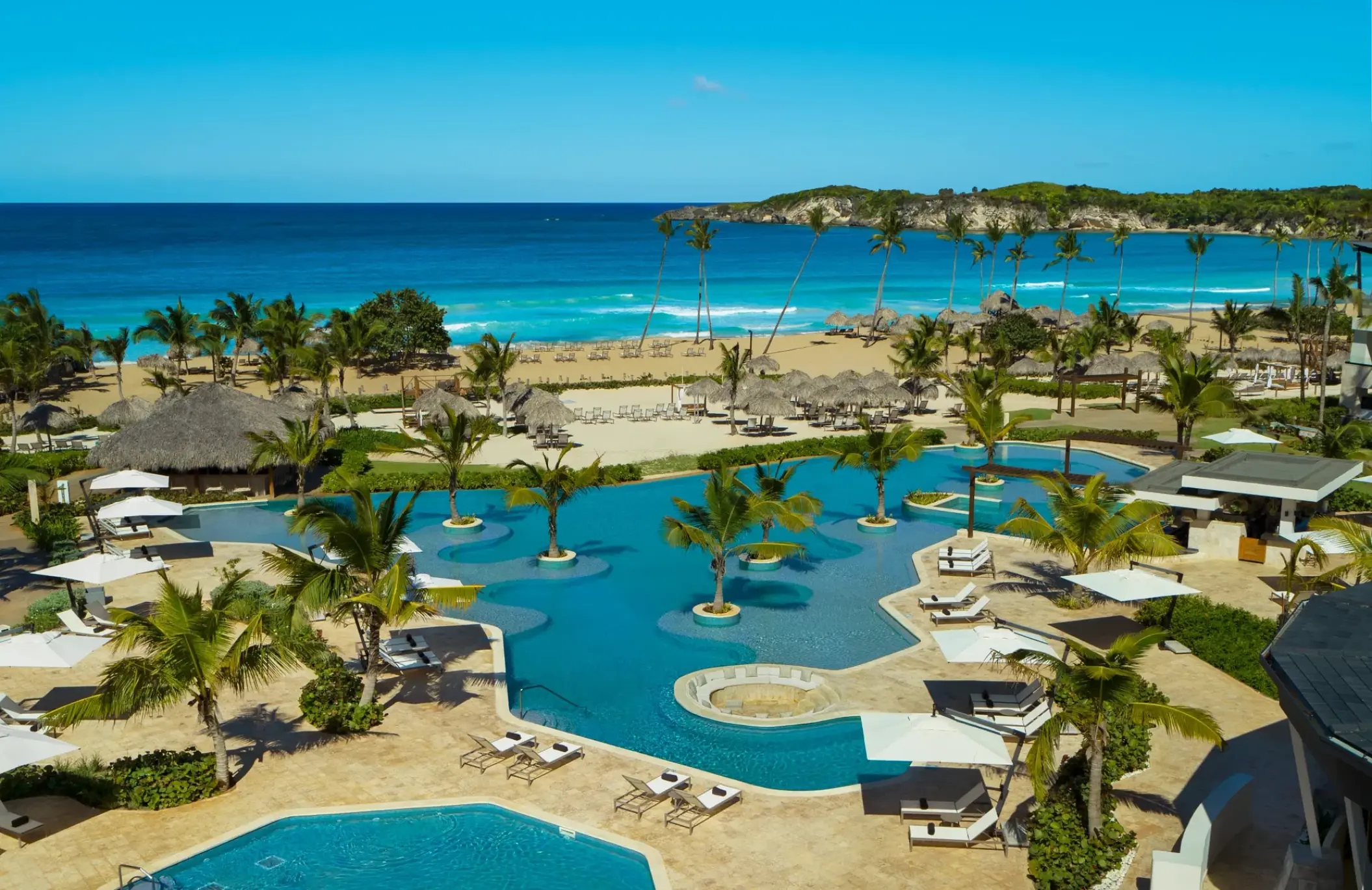 Dreams Macao Beach infinity pool and palm trees overlooking the ocean, Punta Cana