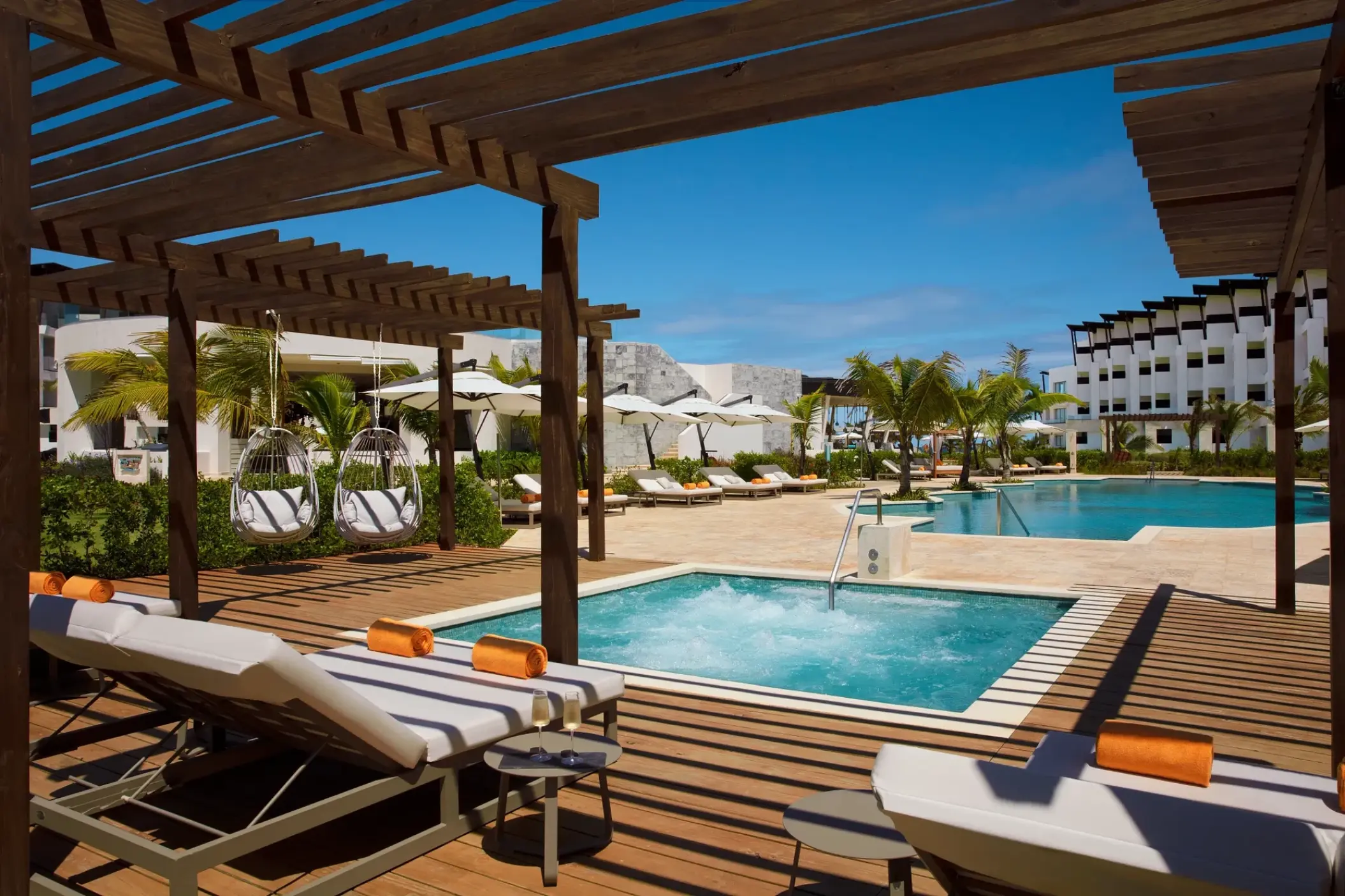 Private hot tub and sun loungers under a wooden pergola at Dreams Macao Beach, Punta Cana