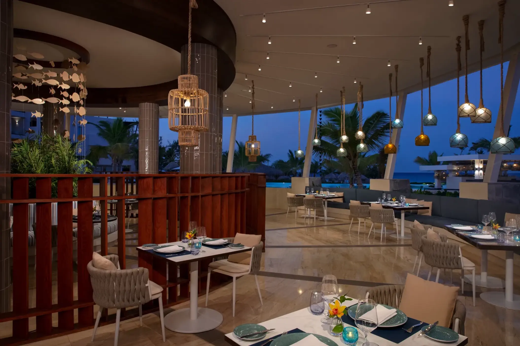 Oceana restaurant at Dreams Macao Beach with outdoor seating and hanging lights, Punta Cana