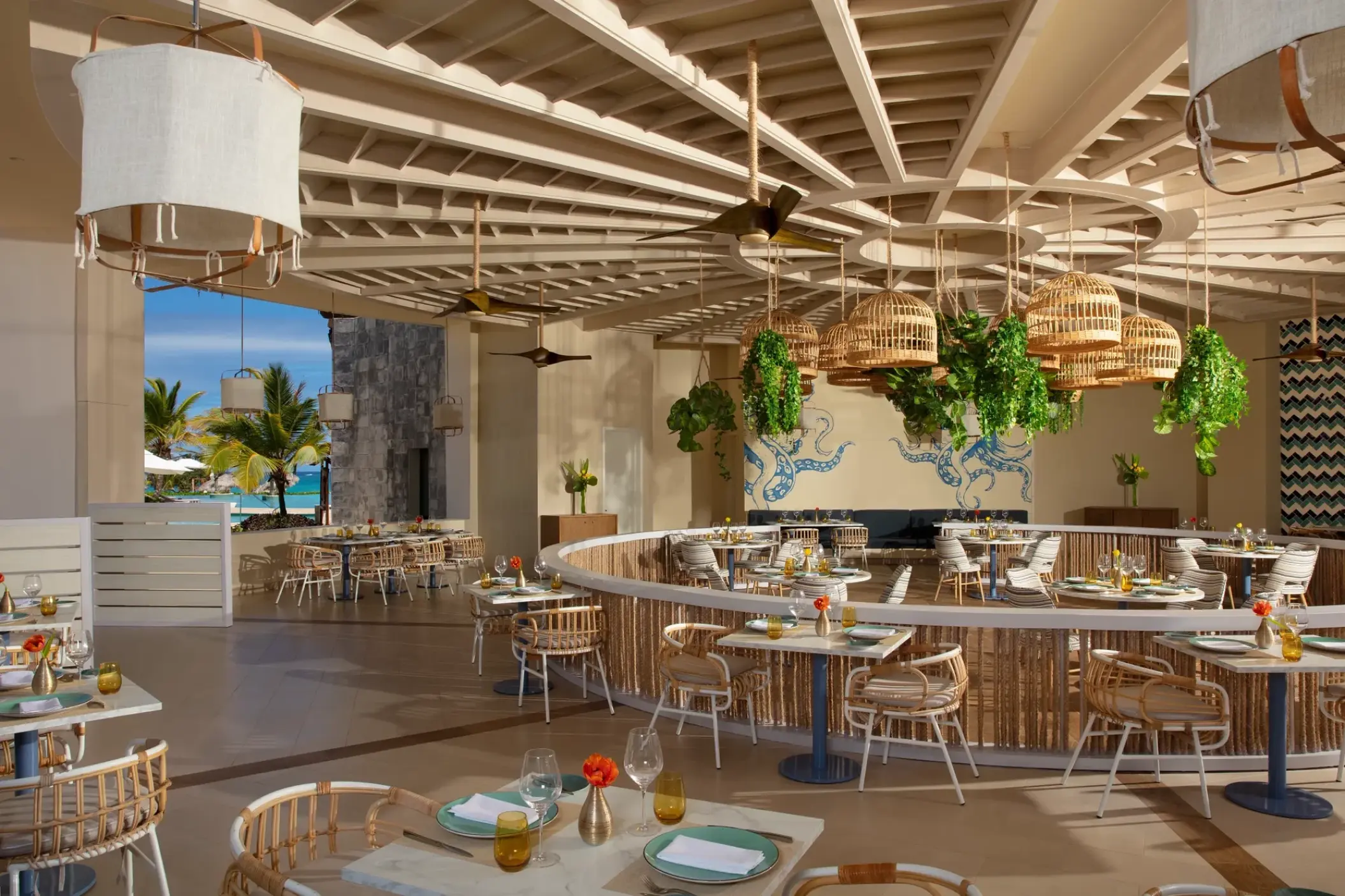 Seaside Grill open-air restaurant with hanging greenery and wicker accents at Dreams Macao Beach, Punta Cana