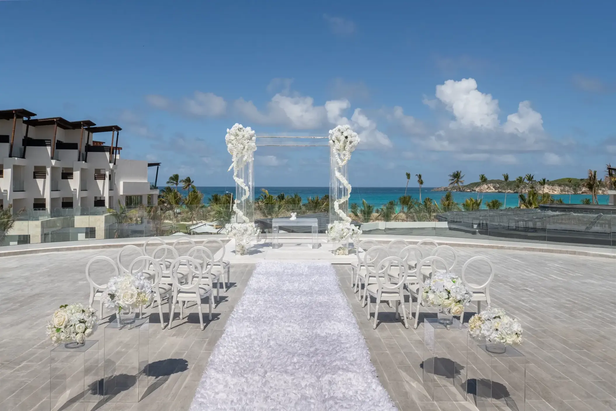 Rooftop wedding ceremony setup with white floral pillars at Dreams Macao Beach, Punta Cana