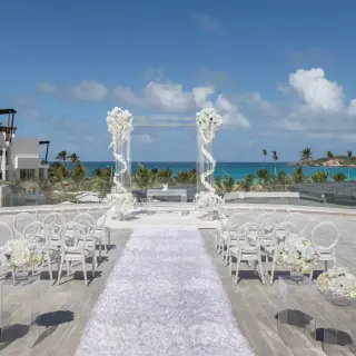 Rooftop wedding ceremony setup with white floral pillars at Dreams Macao Beach, Punta Cana