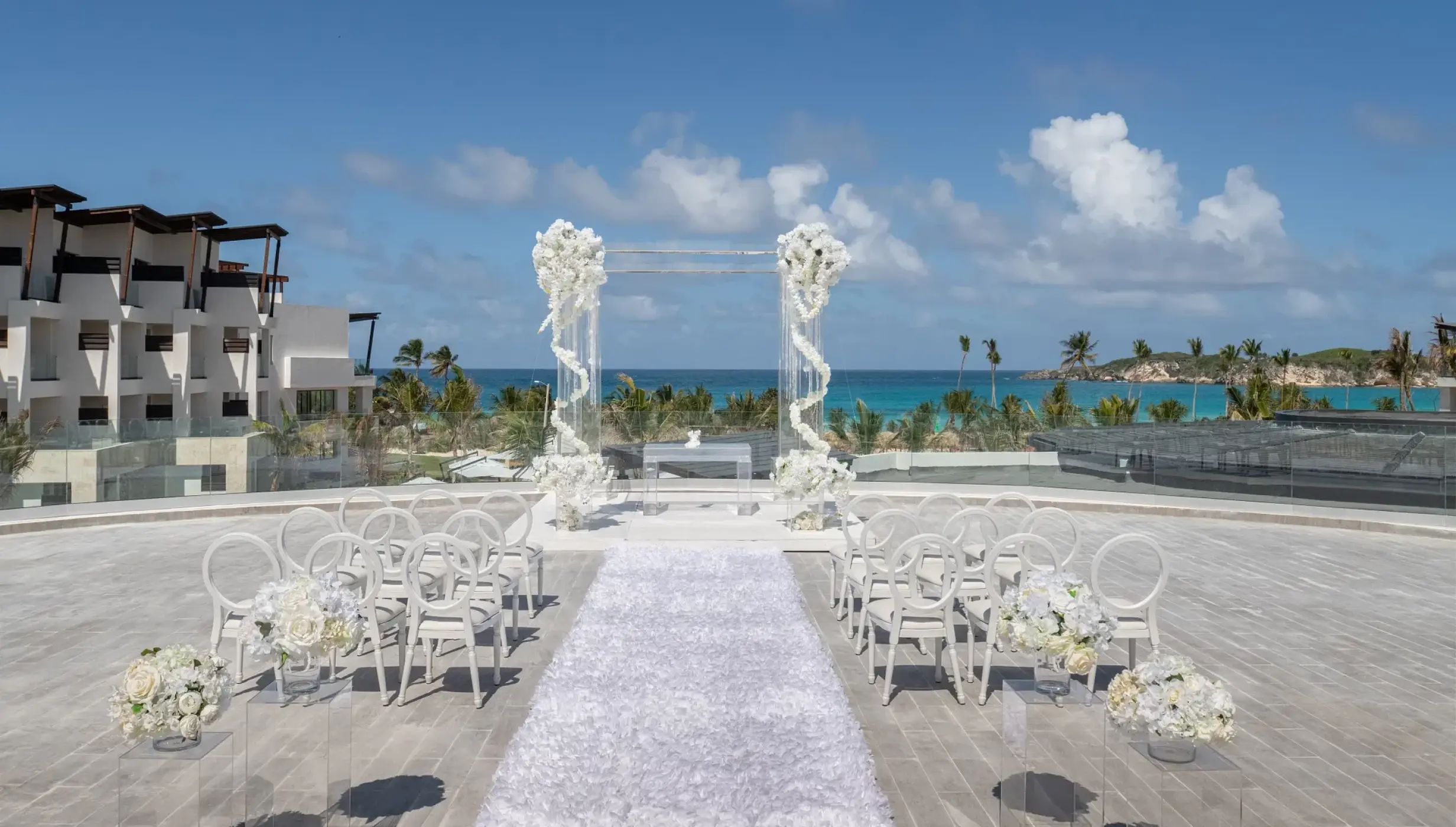 Rooftop wedding ceremony setup with white floral pillars at Dreams Macao Beach, Punta Cana