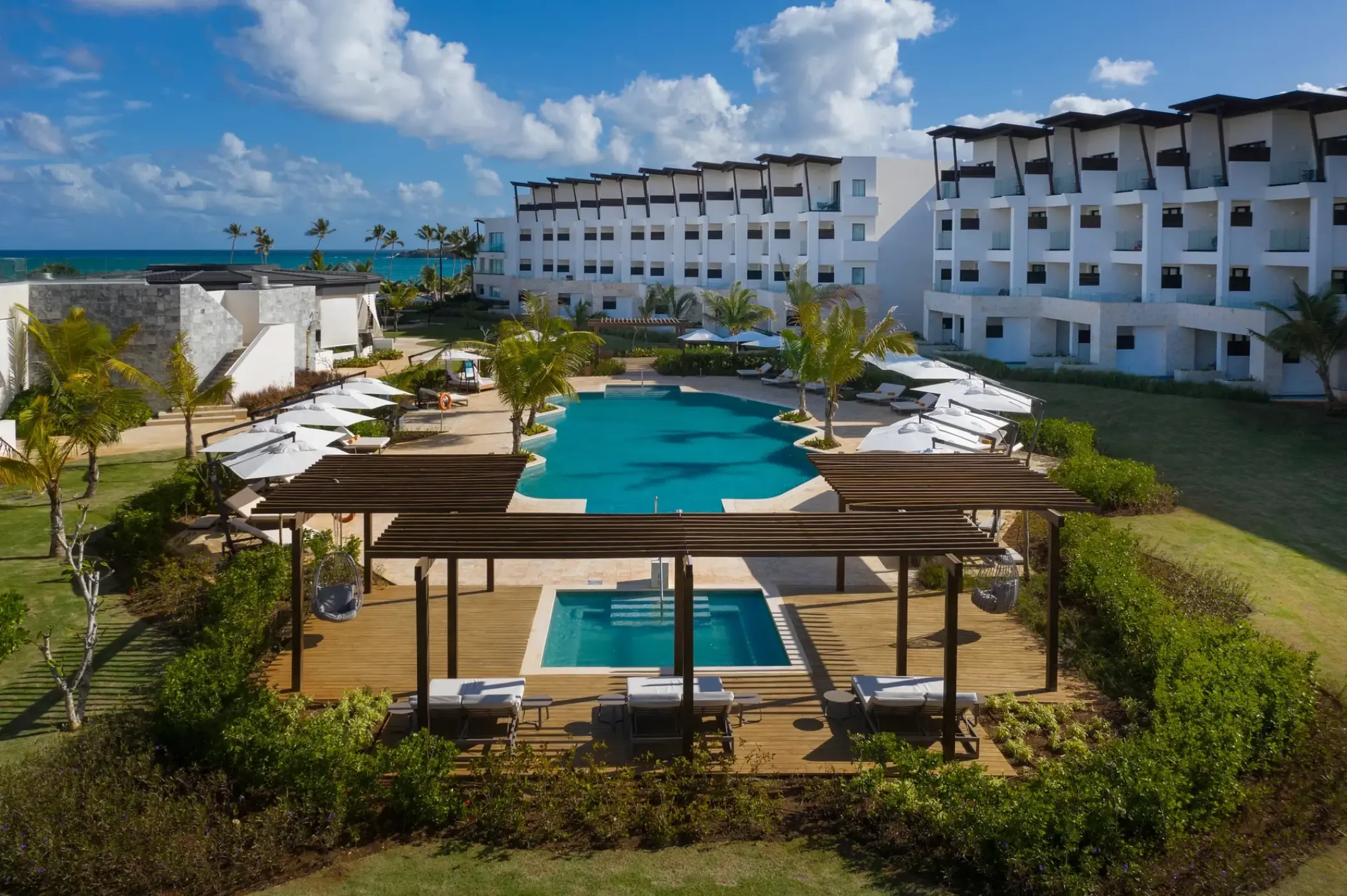 Pool and relaxation deck with wooden pergolas at Dreams Macao Beach, Punta Cana