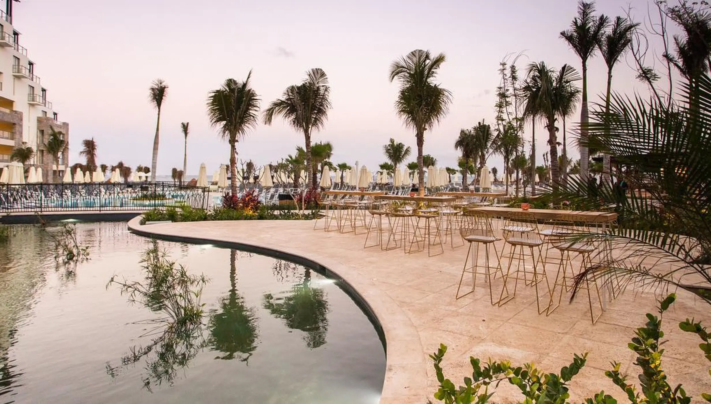 Outdoor wedding reception setup on the fishpond terrace at Dreams Natura, Riviera Maya