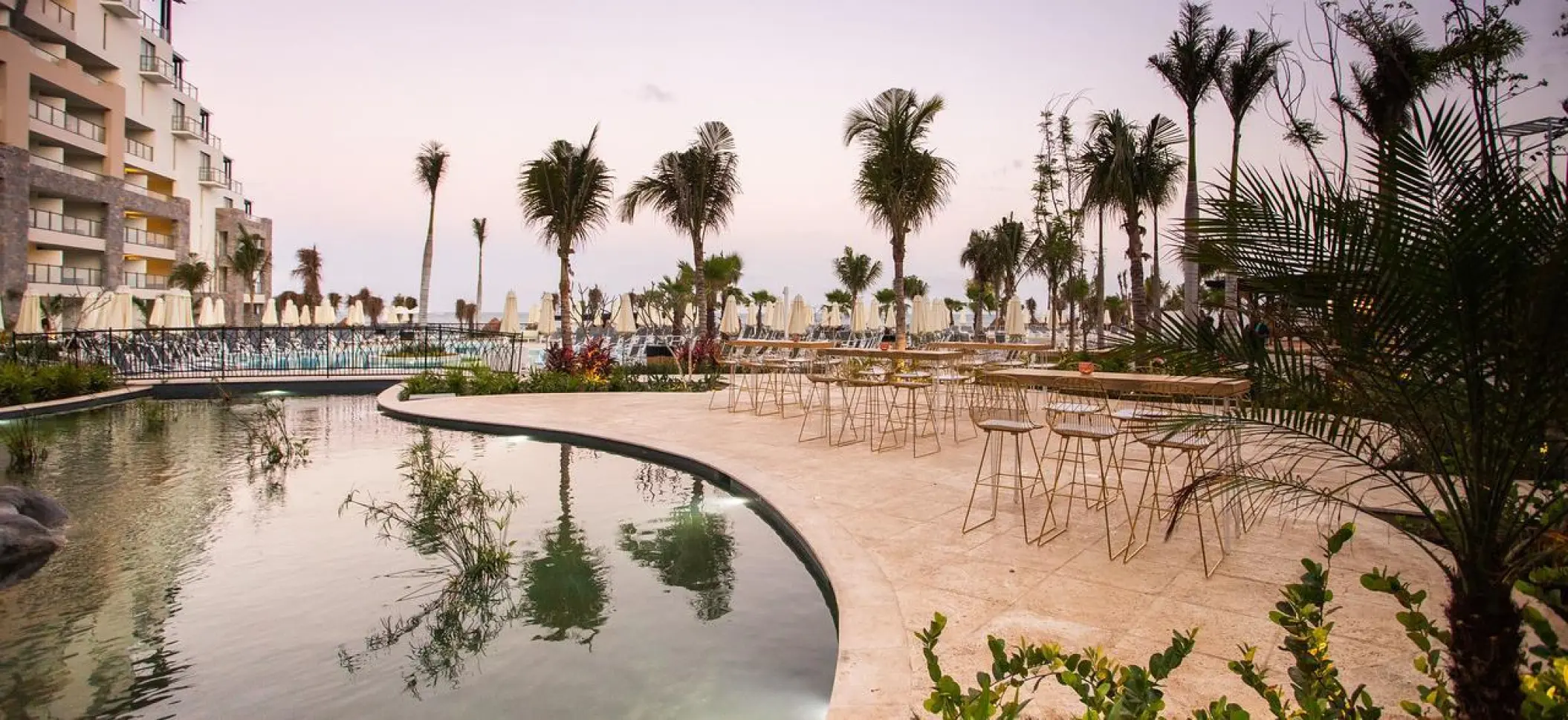 Outdoor wedding reception setup on the fishpond terrace at Dreams Natura, Riviera Maya