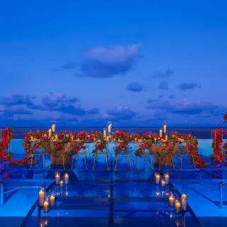 Infinity wedding reception red flowers at Dreams Natura Resort and Spa