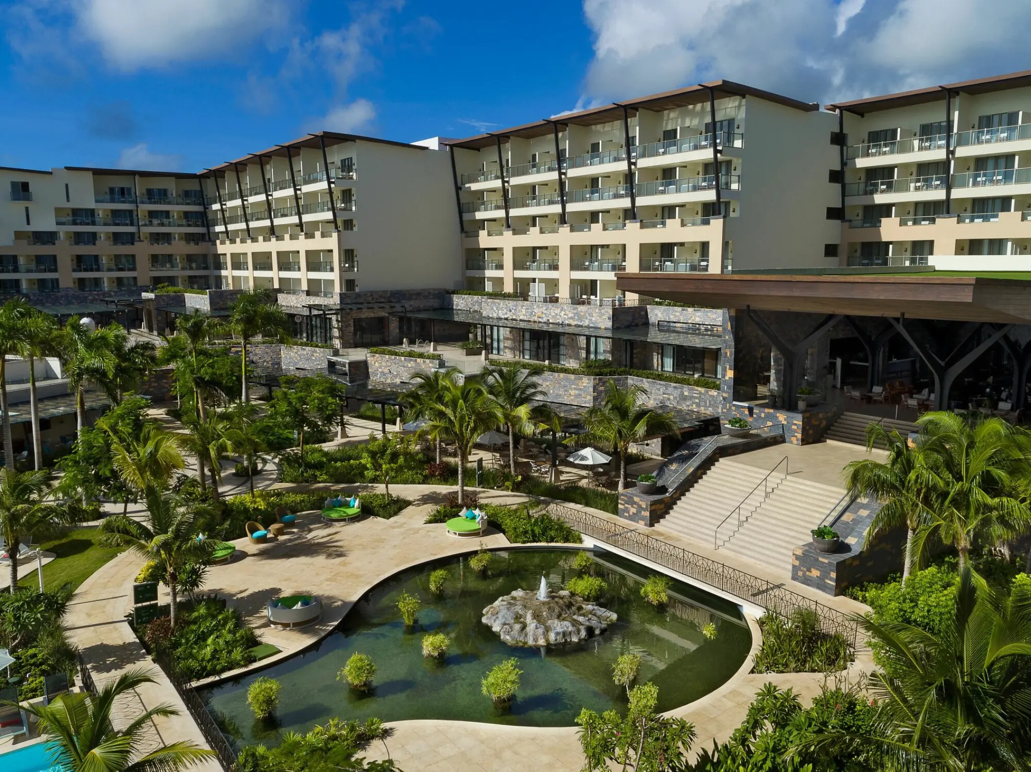 Panoramic view of the tropical gardens and guest room buildings at Dreams Natura