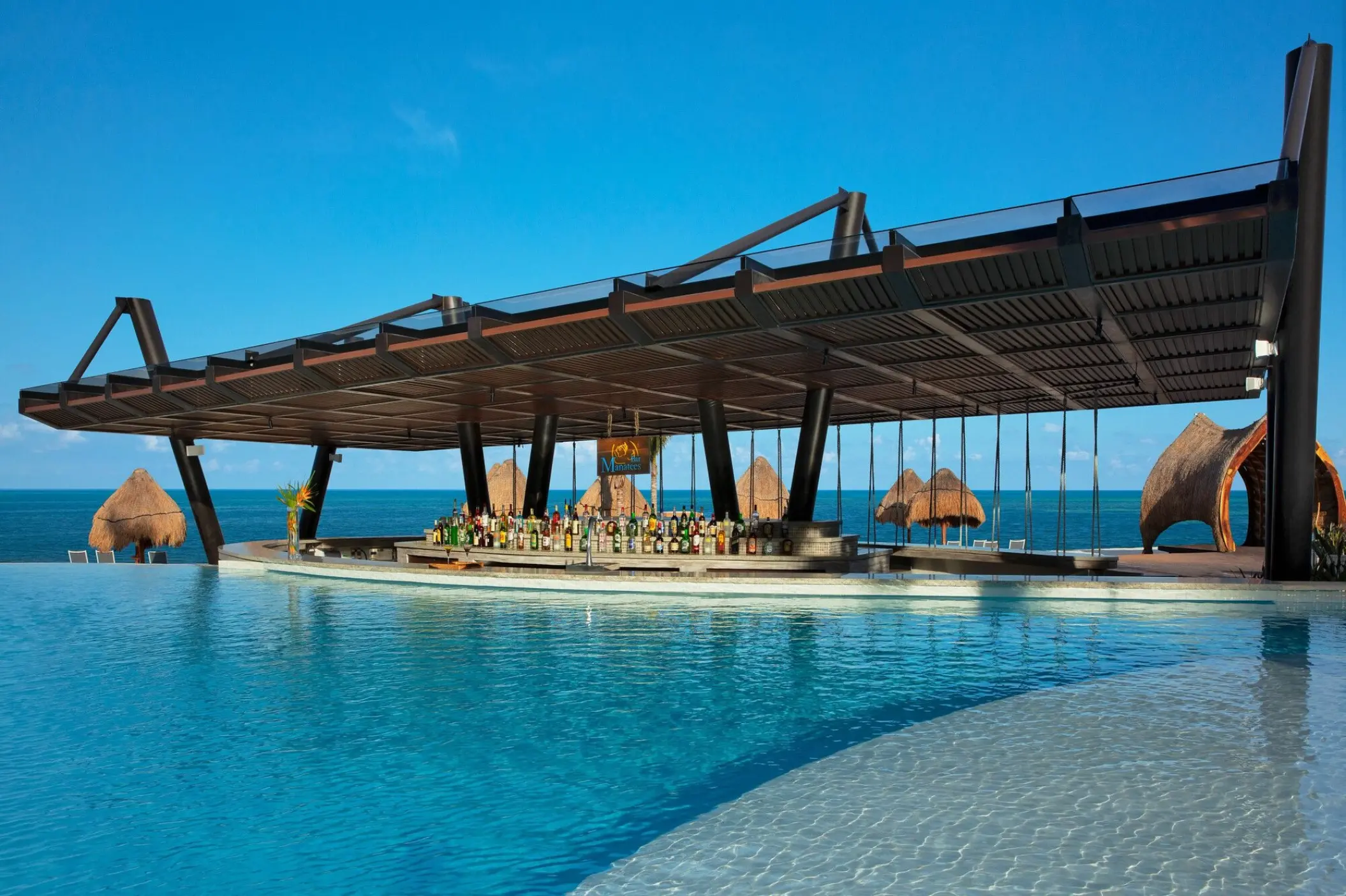 Swim-up bar with a modern wooden roof at Dreams Natura, Riviera Maya