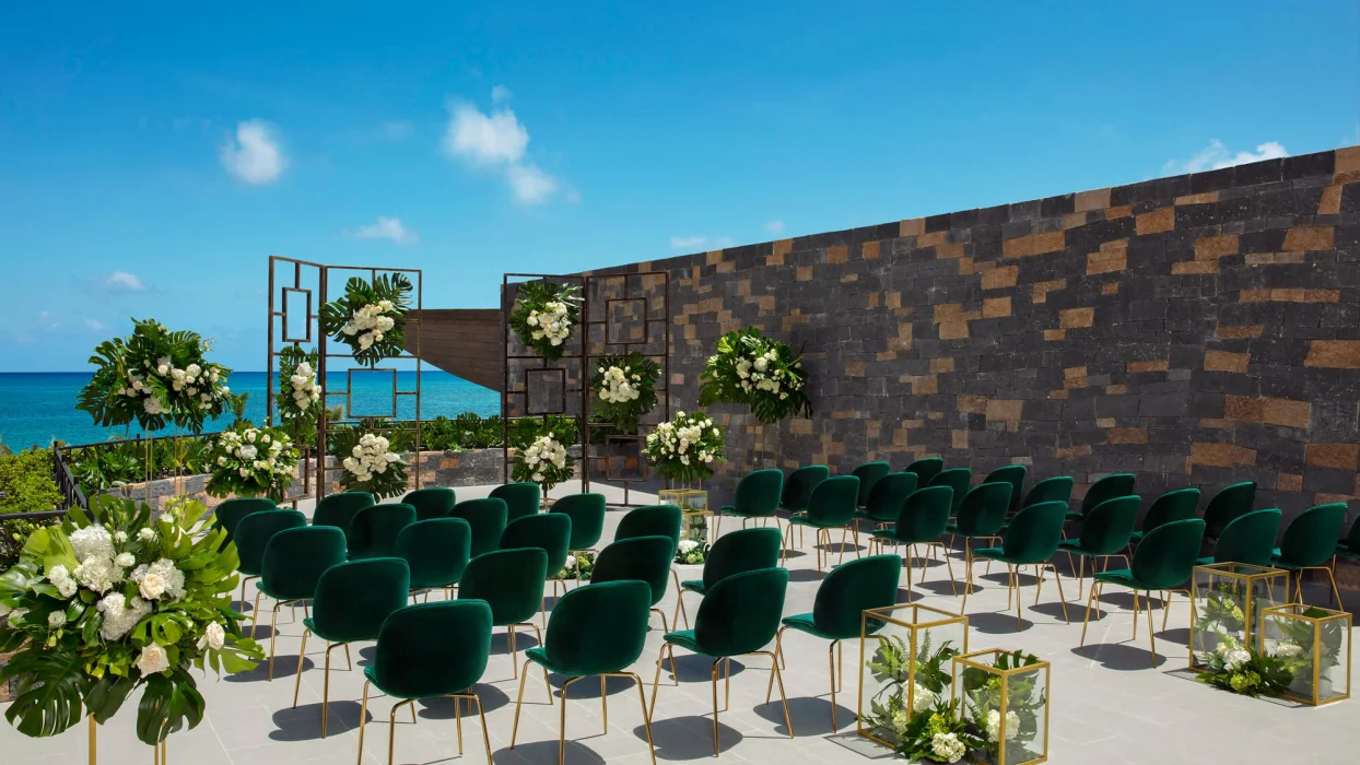 Wedding terrace with green chairs and altar at Dreams Natura Resort and Spa