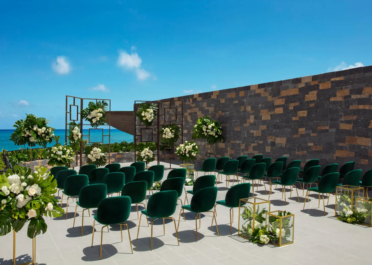 Wedding terrace with green chairs and altar at Dreams Natura Resort and Spa