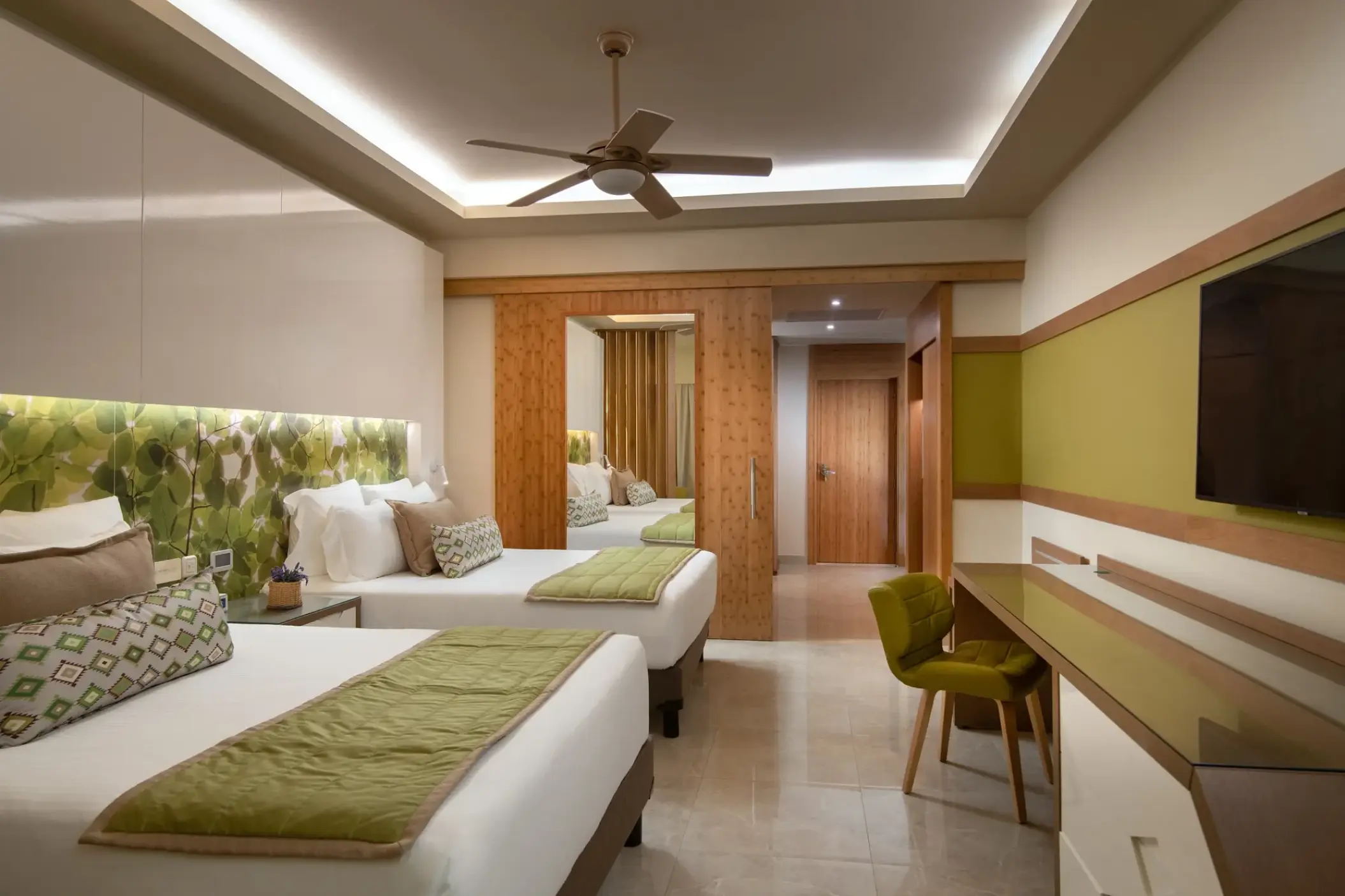 Modern family room with two beds and a desk at Dreams Onyx, Punta Cana