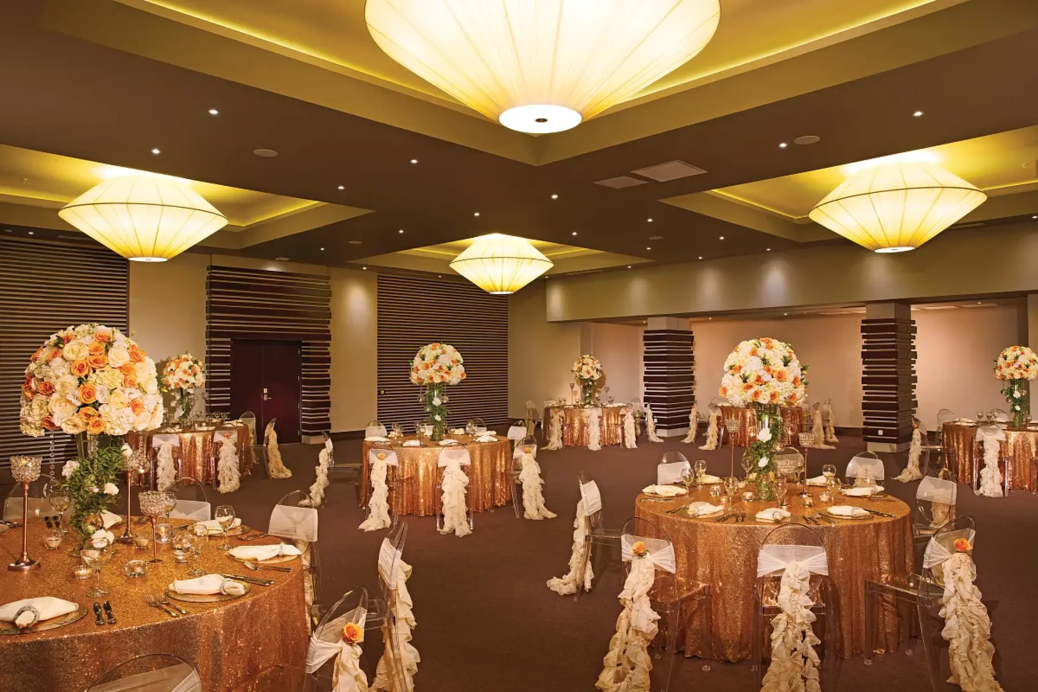 Gold sequin wedding reception tables in the ballroom at Dreams Onyx, Punta Cana