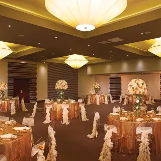 Gold sequin wedding reception tables in the ballroom at Dreams Onyx, Punta Cana