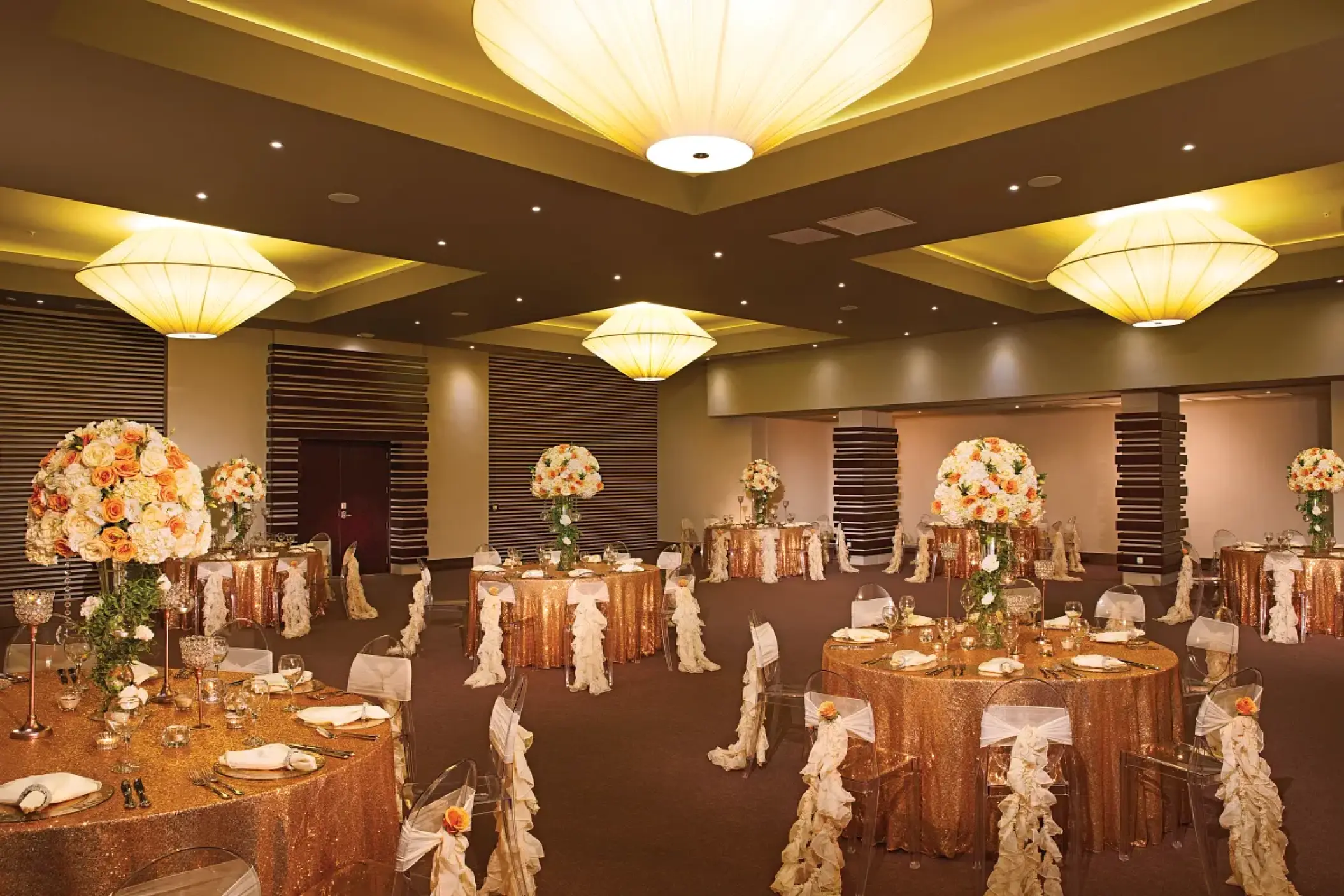 Gold sequin wedding reception tables in the ballroom at Dreams Onyx, Punta Cana
