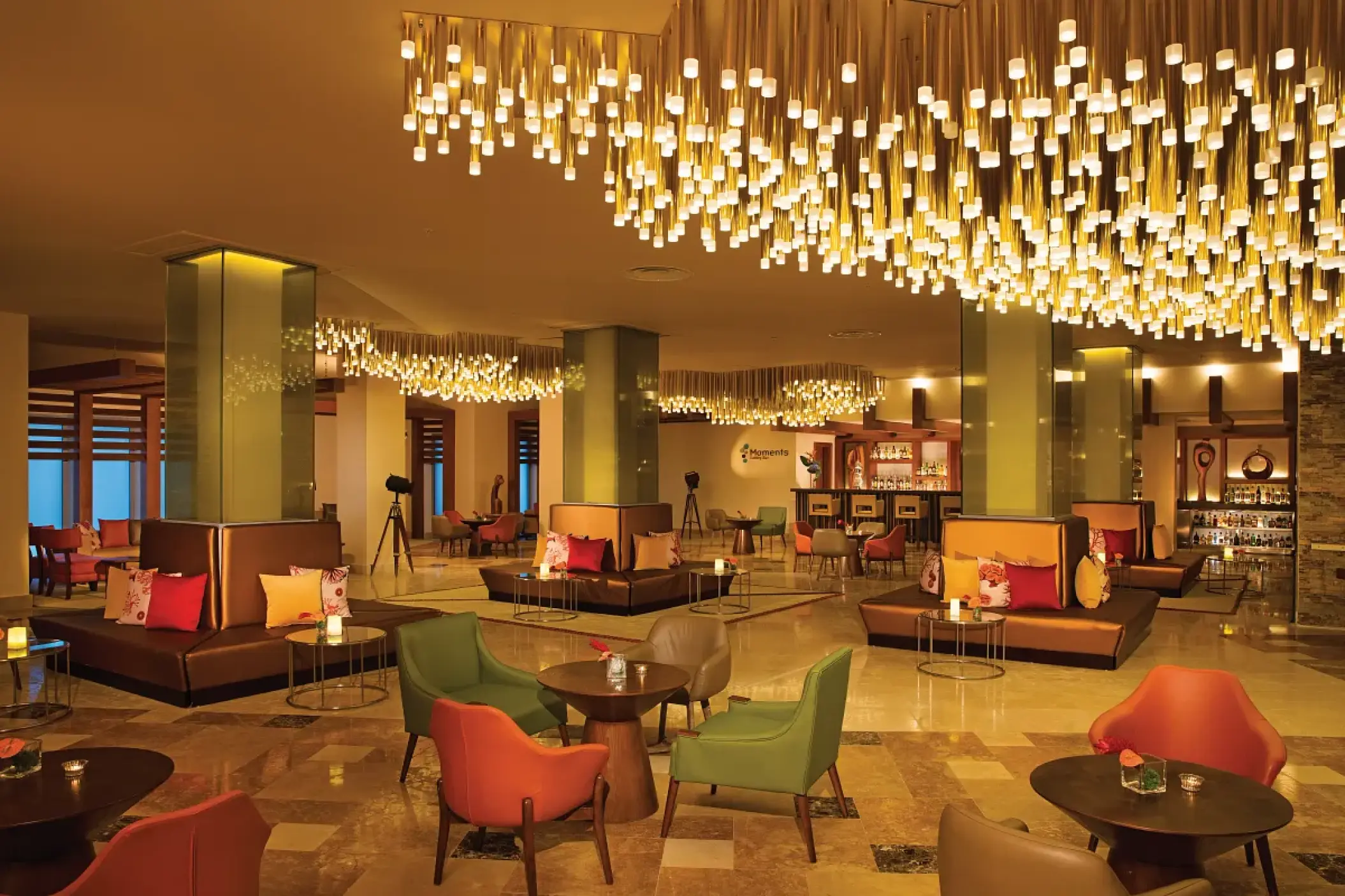 Moments lounge at Dreams Onyx featuring modern seating and a unique light installation, Punta Cana