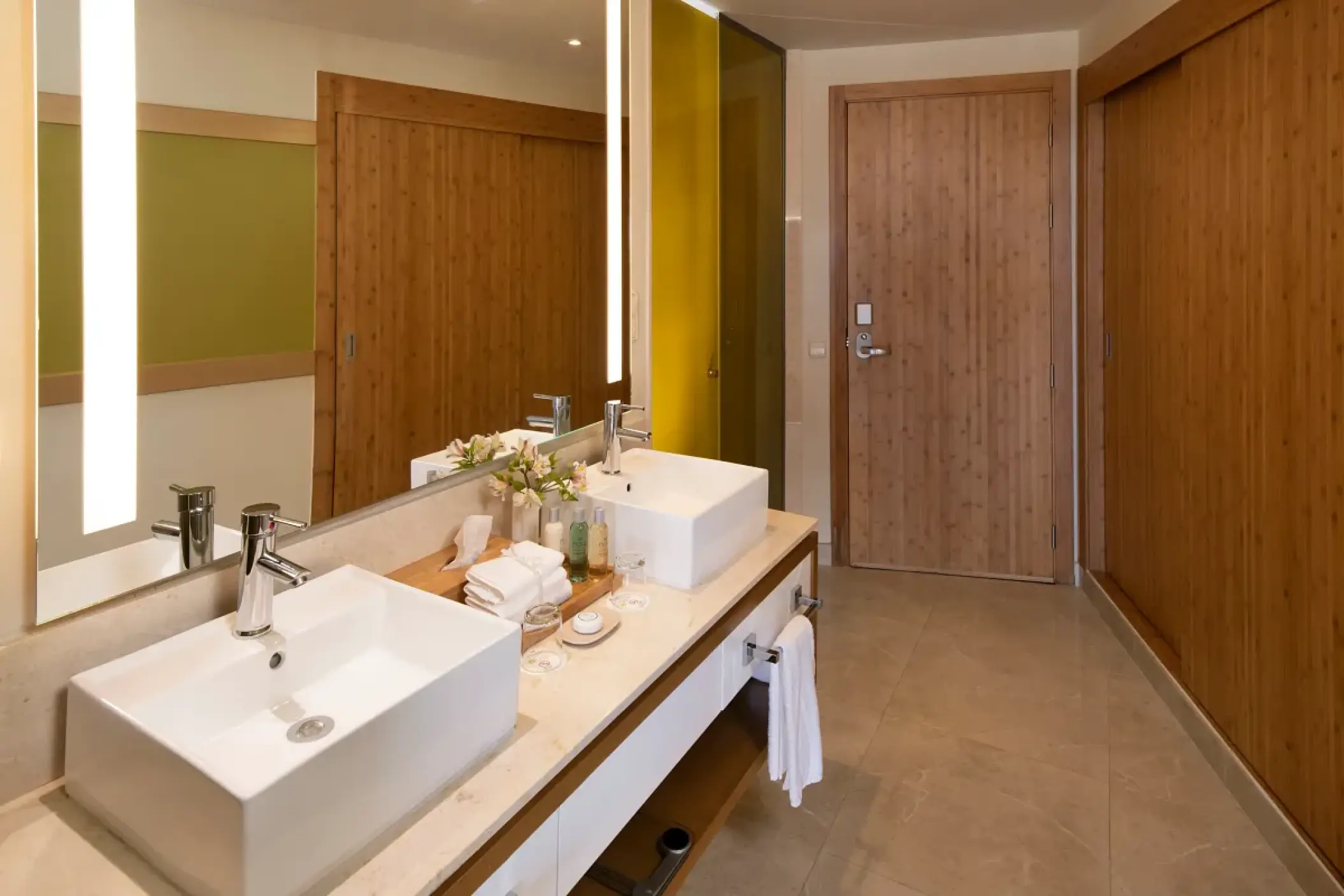 Double vanity suite bathroom with wood paneling at Dreams Onyx, Punta Cana