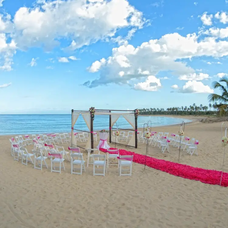 Beachfront wedding ceremony setup with pink runner at Dreams Onyx, Punta Cana
