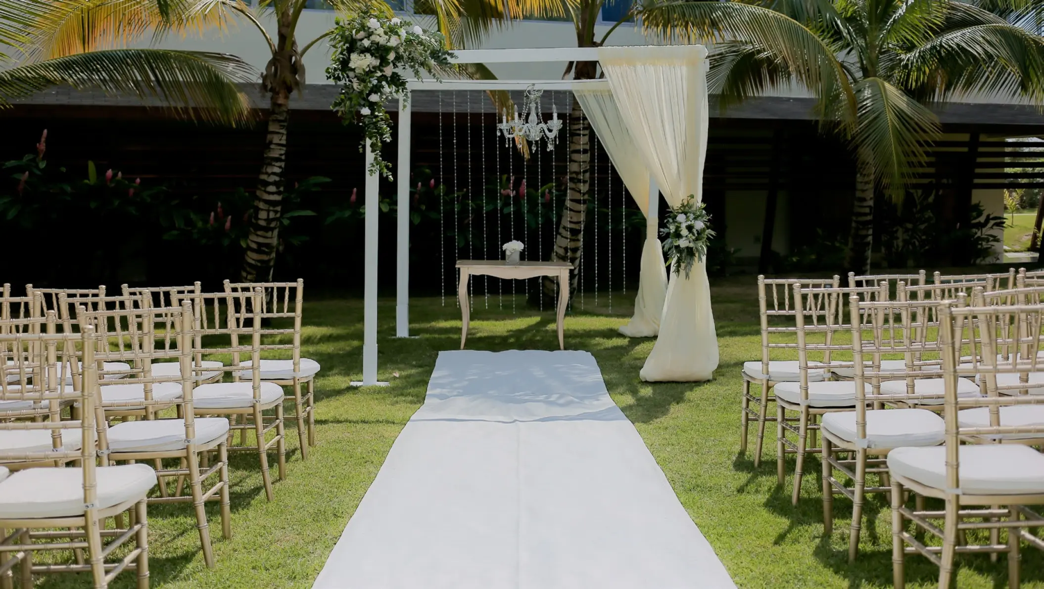 Garden wedding ceremony setup with white aisle runner and gazebo at Dreams Onyx, Punta Cana