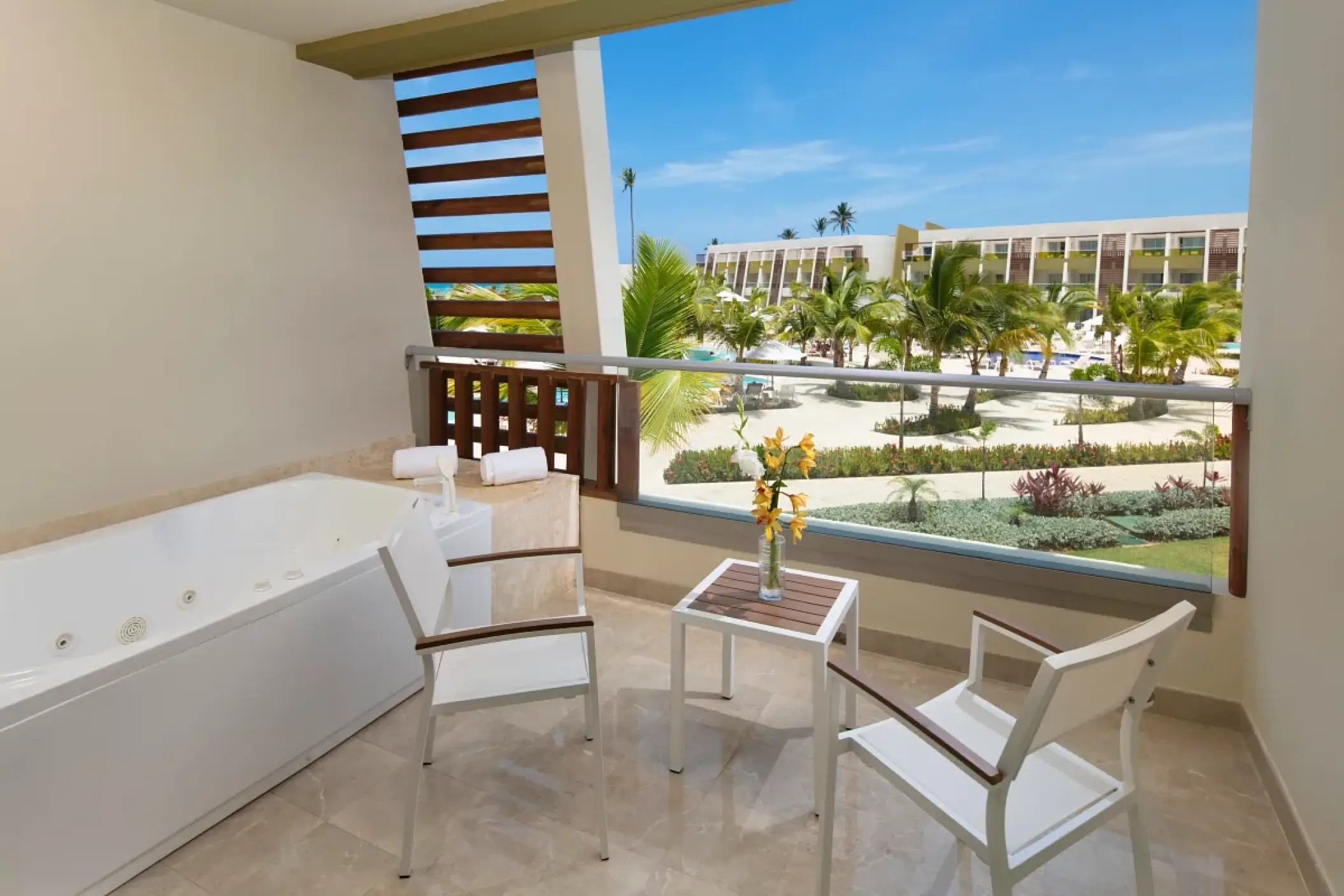 Junior suite terrace with a whirlpool tub overlooking the grounds at Dreams Onyx, Punta Cana