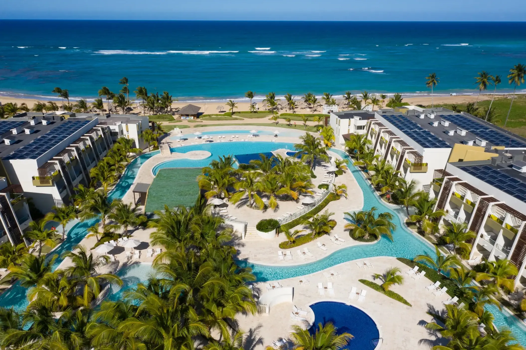 Aerial view of Dreams Onyx pools and guest room buildings along the beach, Punta Cana