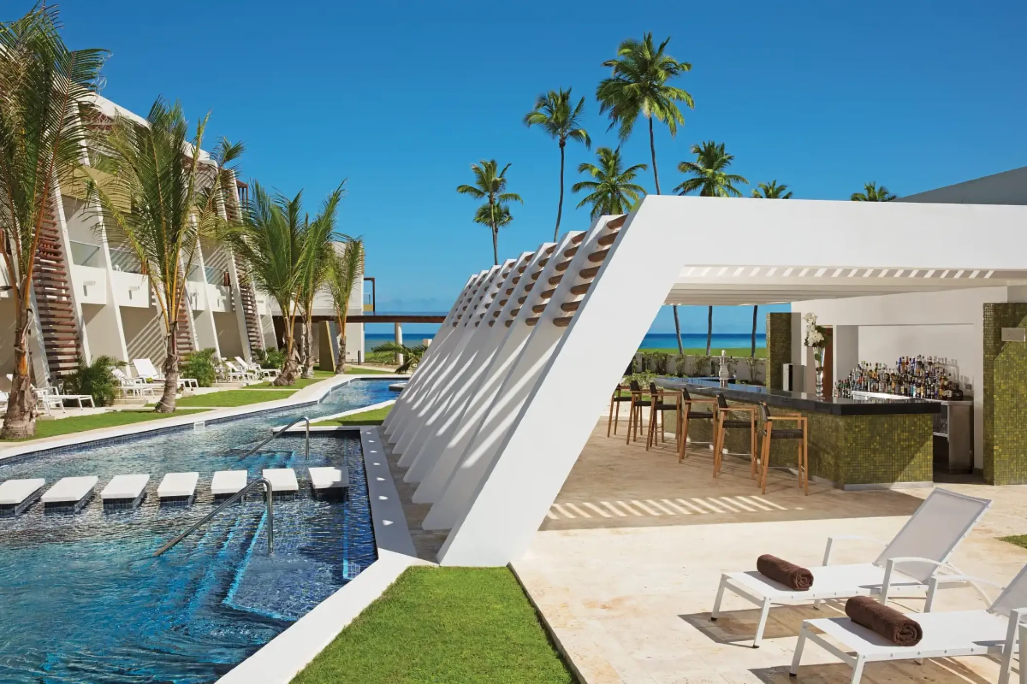Modern swim-up pool bar and lounge area at Dreams Onyx, Punta Cana