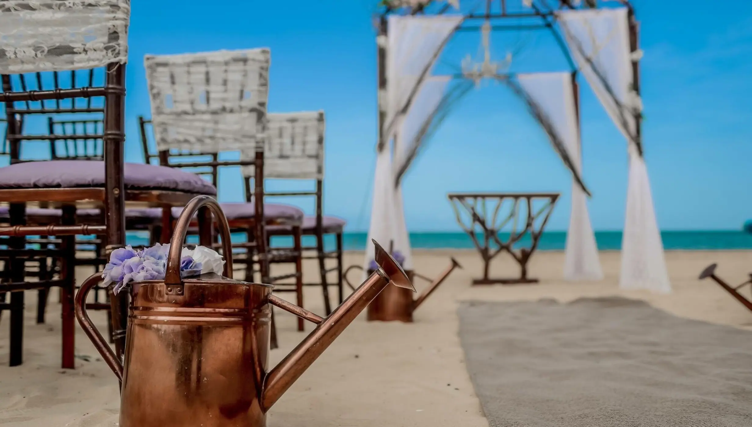 Ceremony decor on the stone beach at Dreams Onyx Resort & Spa