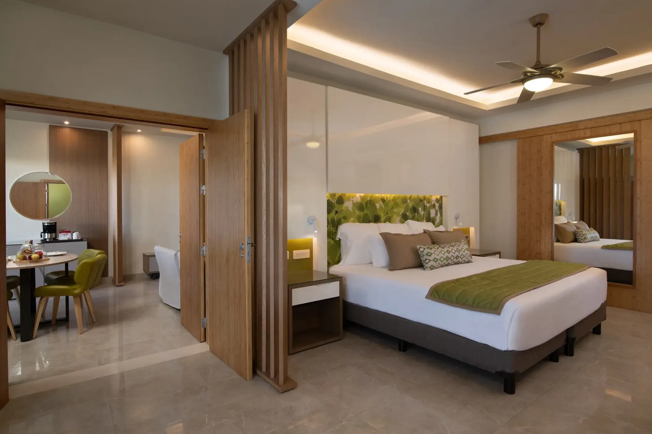 Family suite with king bed and separate dining area at Dreams Onyx, Punta Cana