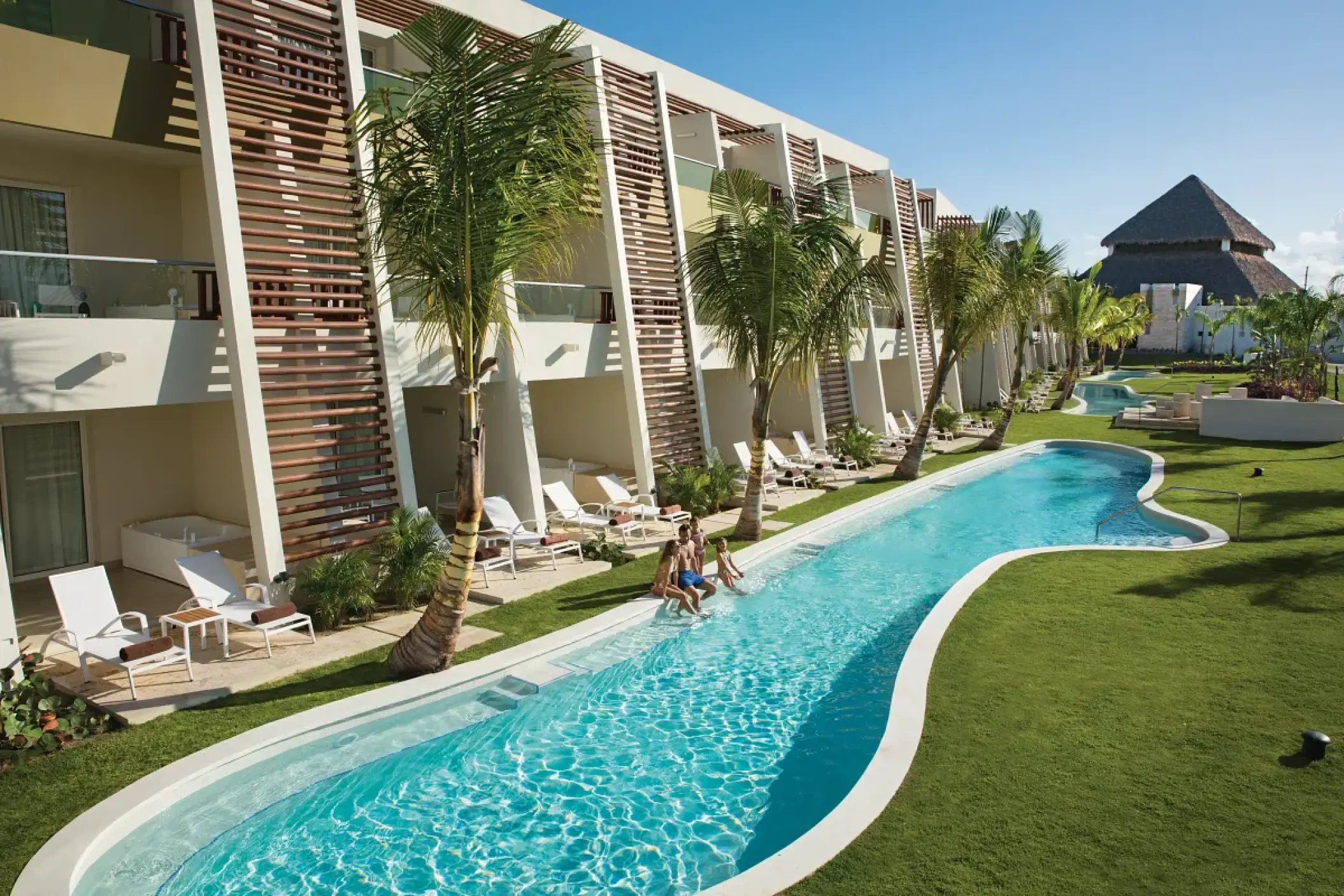 Dreams Onyx swim-up suites with a winding river pool and palm trees, Punta Cana