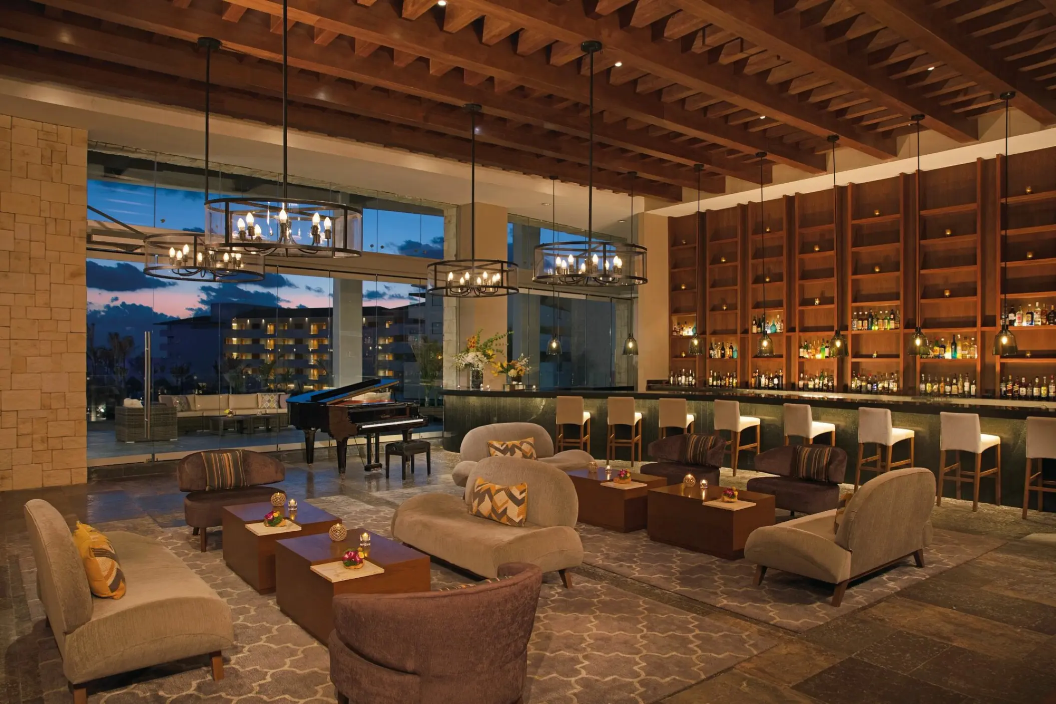 Indoor lobby bar with lounge seating and grand piano at Dreams Playa Mujeres, Cancun