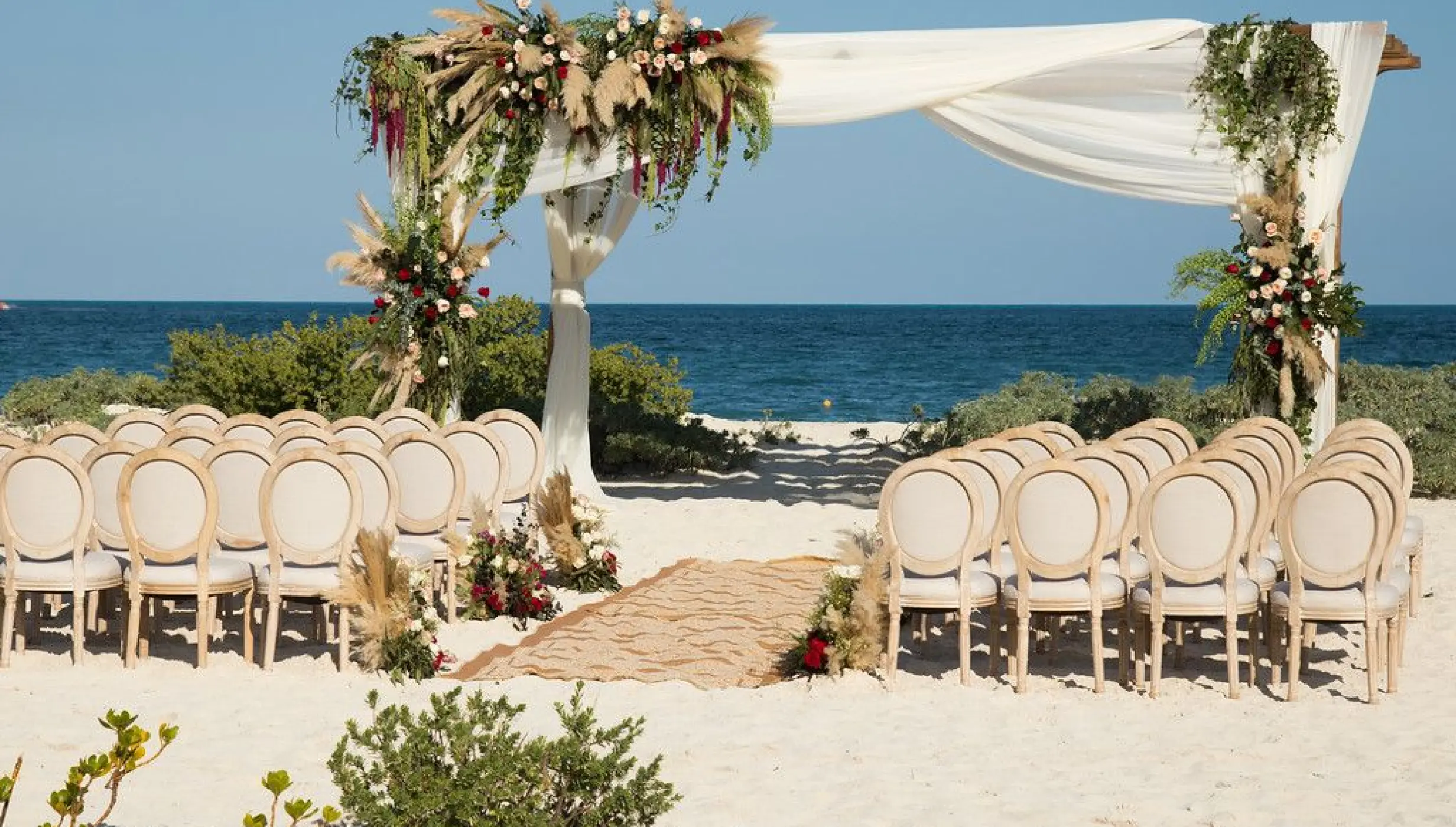 Dreams Playa Mujeres beach wedding venue with flowers and canopy