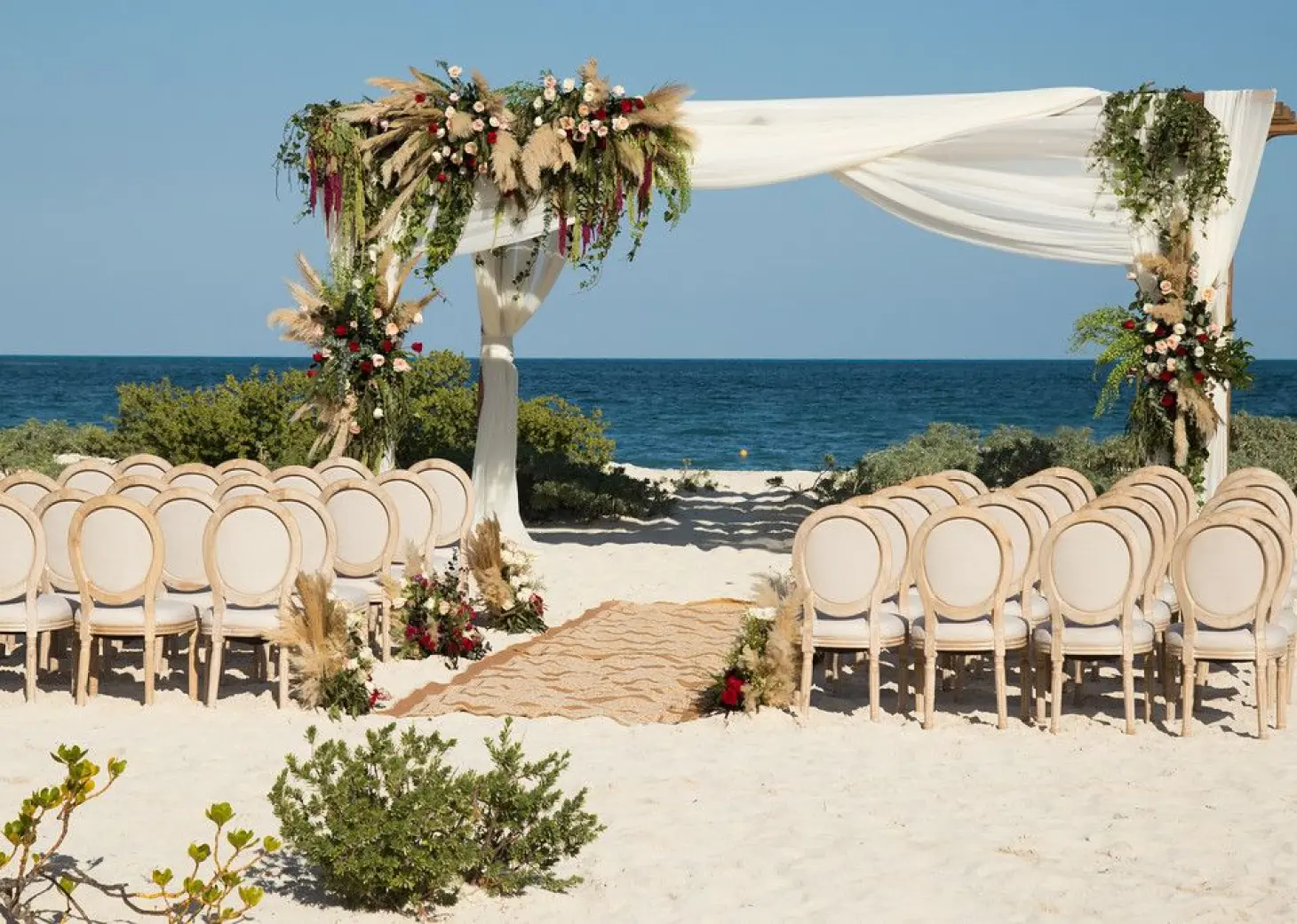 Dreams Playa Mujeres beach wedding venue with flowers and canopy