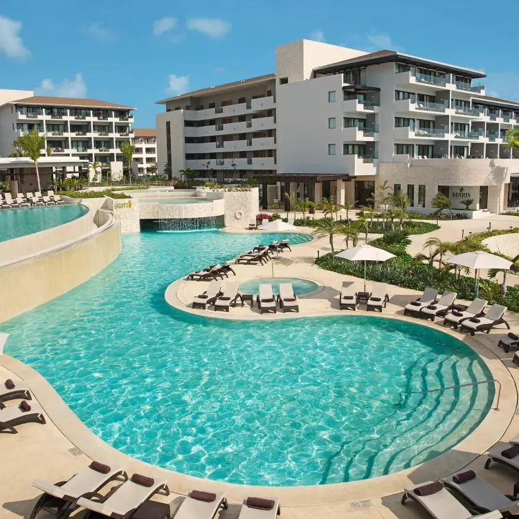Curved grotto pool and sun loungers at Dreams Playa Mujeres, Cancun