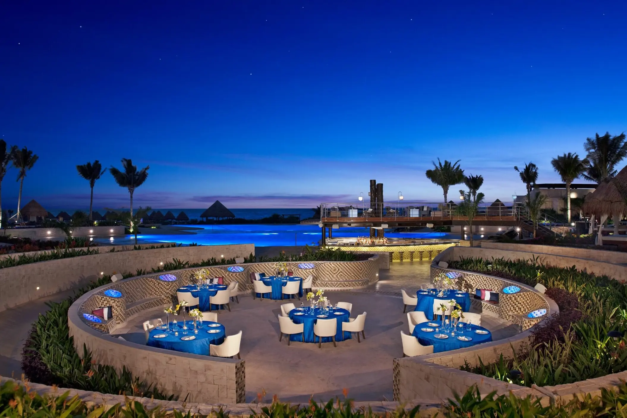 Evening wedding reception with blue linens at Dreams Playa Mujeres, Cancun
